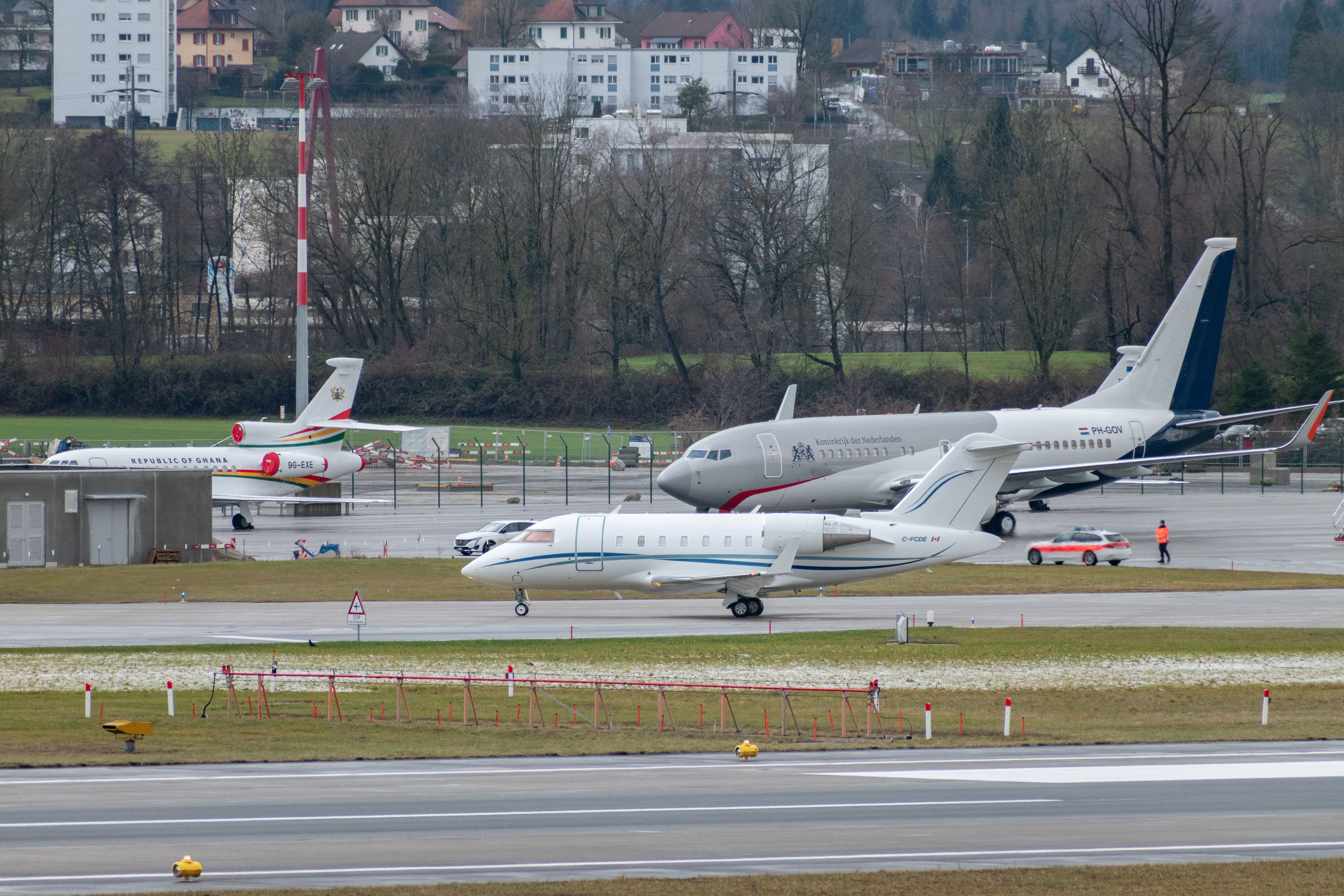 Several business jets on an airport apron.
