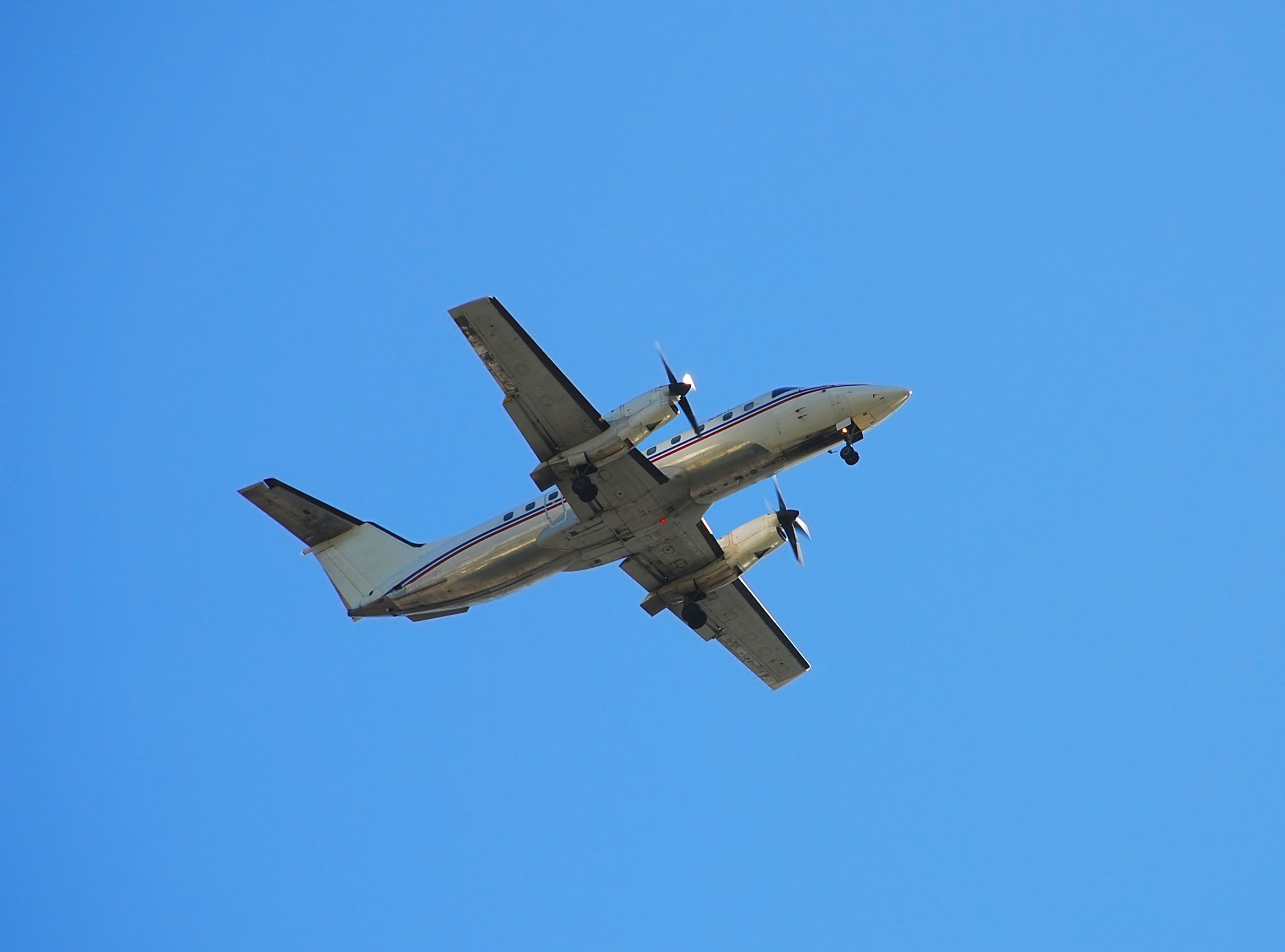 An Embraer EMB-120 turboprop flying in the sky.