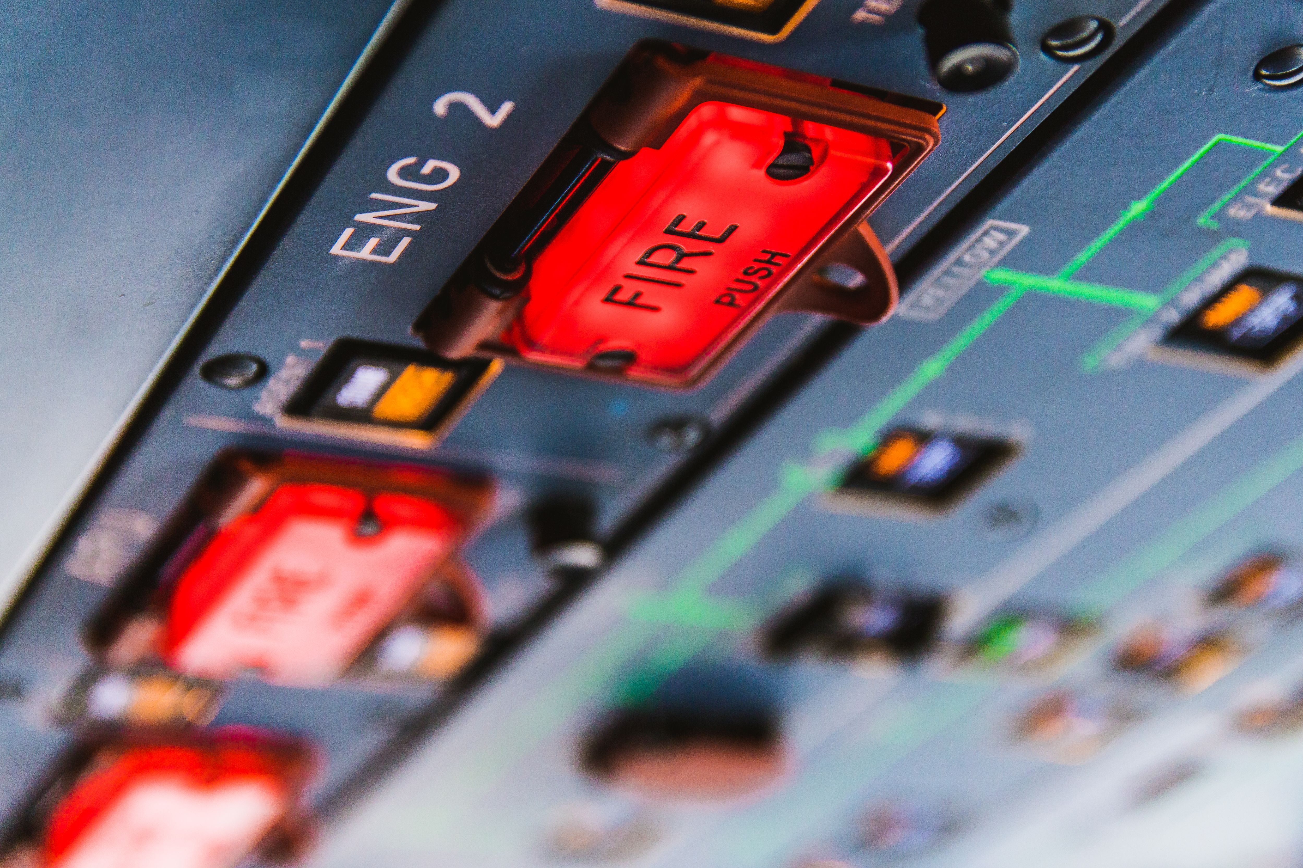 The overhead fire protection buttons in an airbus A320 cockpit.