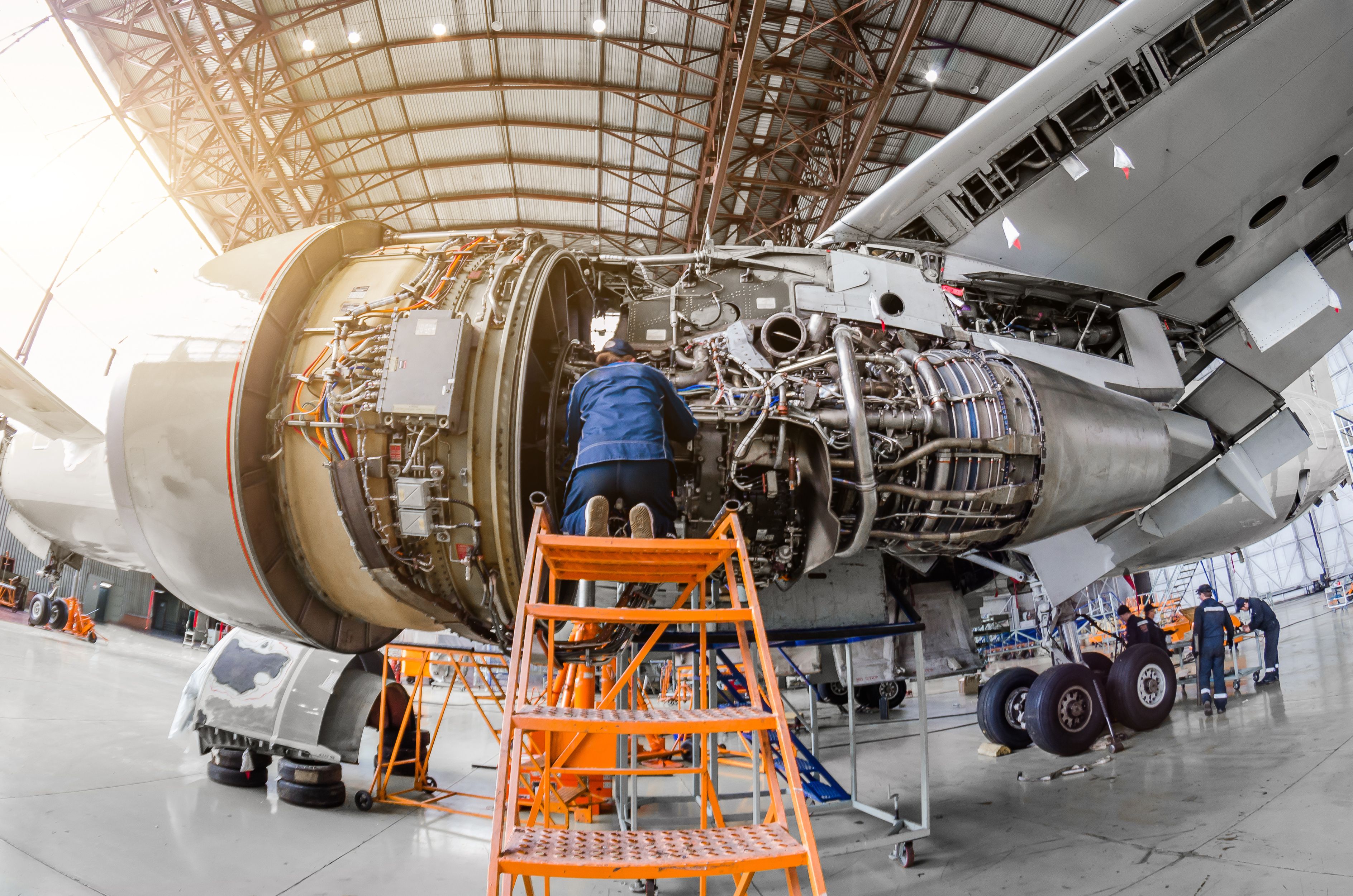 shutterstock_727853458 - Specialist mechanic repairs the maintenance of a large engine of a passenger aircraft in a hangar