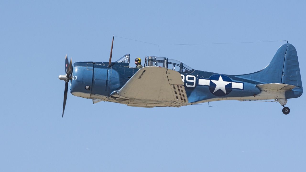 A Douglas SBD-5 Dauntless flying in the sky.