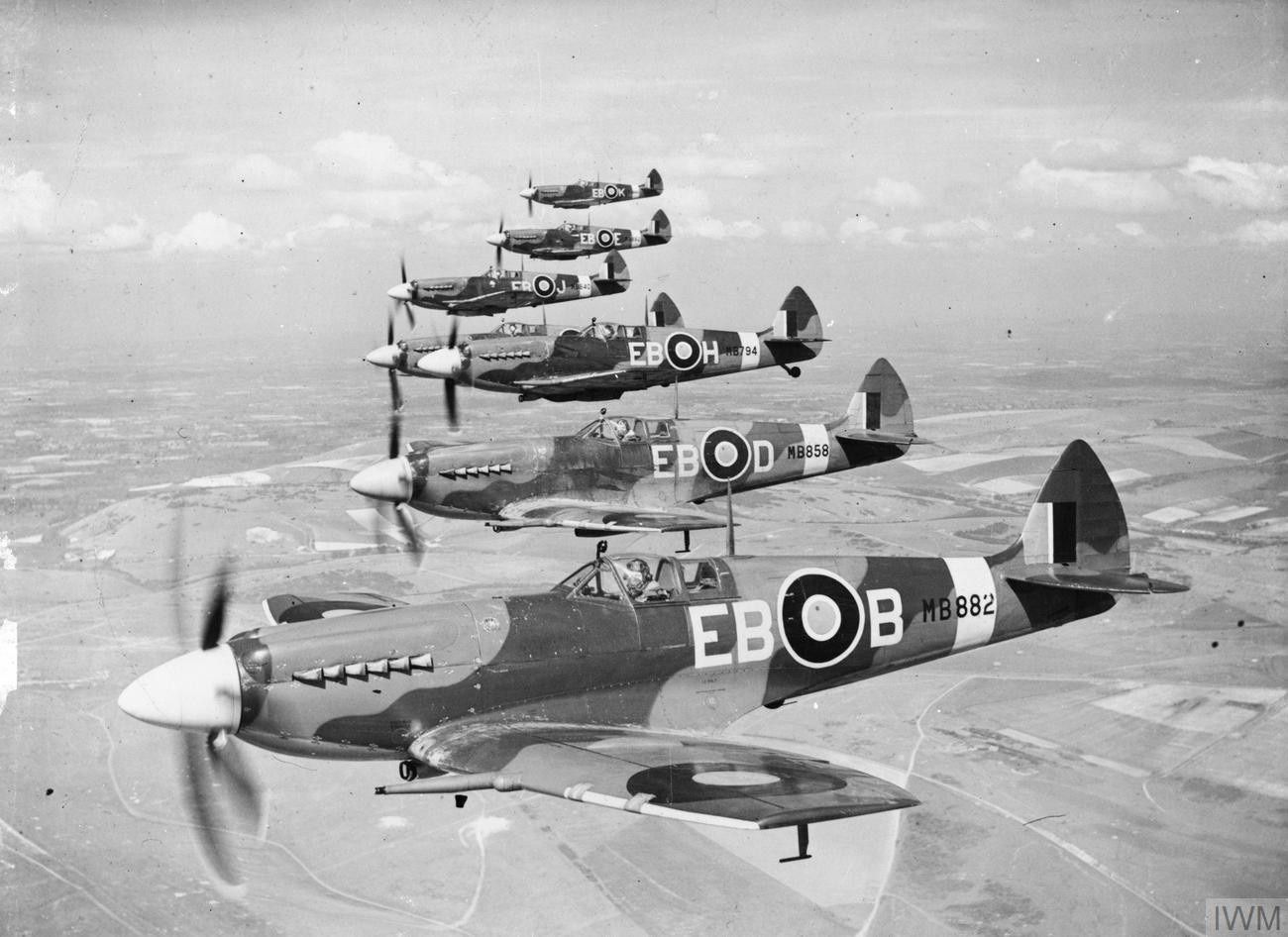 Several Supermarine Spitfires flying in the sky.
