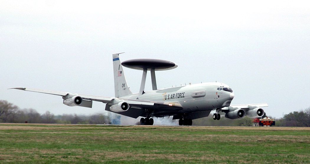 A USAF E-3 Sentry landing on an runway.
