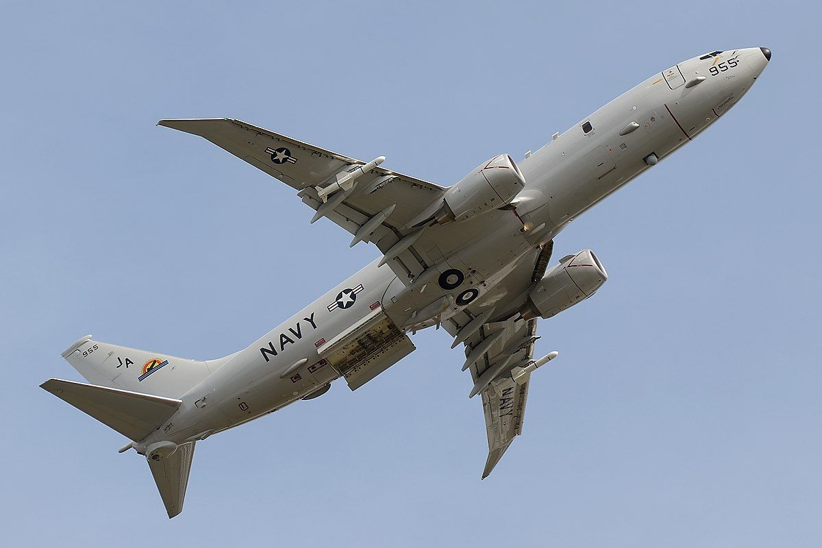 A P-8 Poseidon flying in the sky.