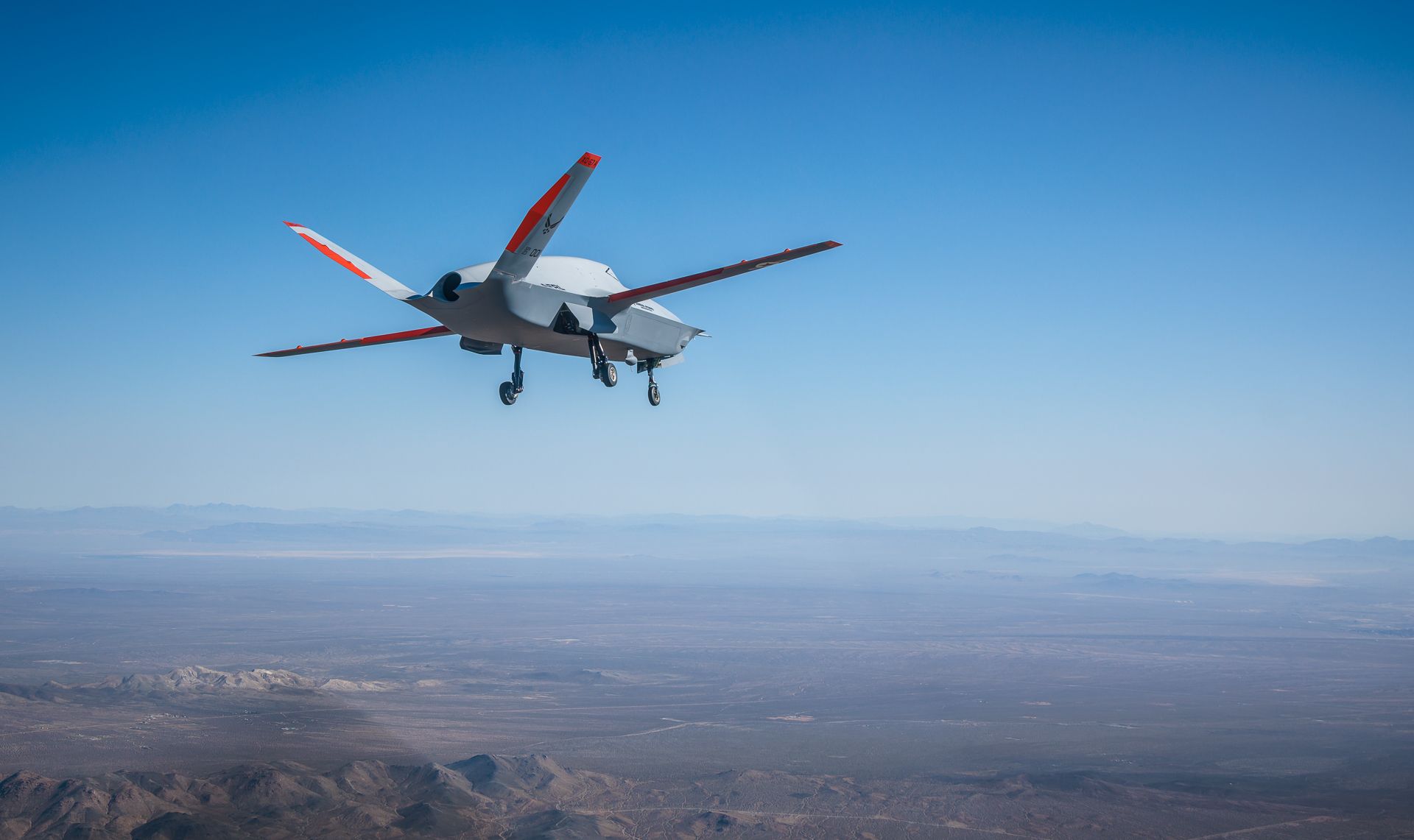 A General Atomics XQ-67 flying in the sky.