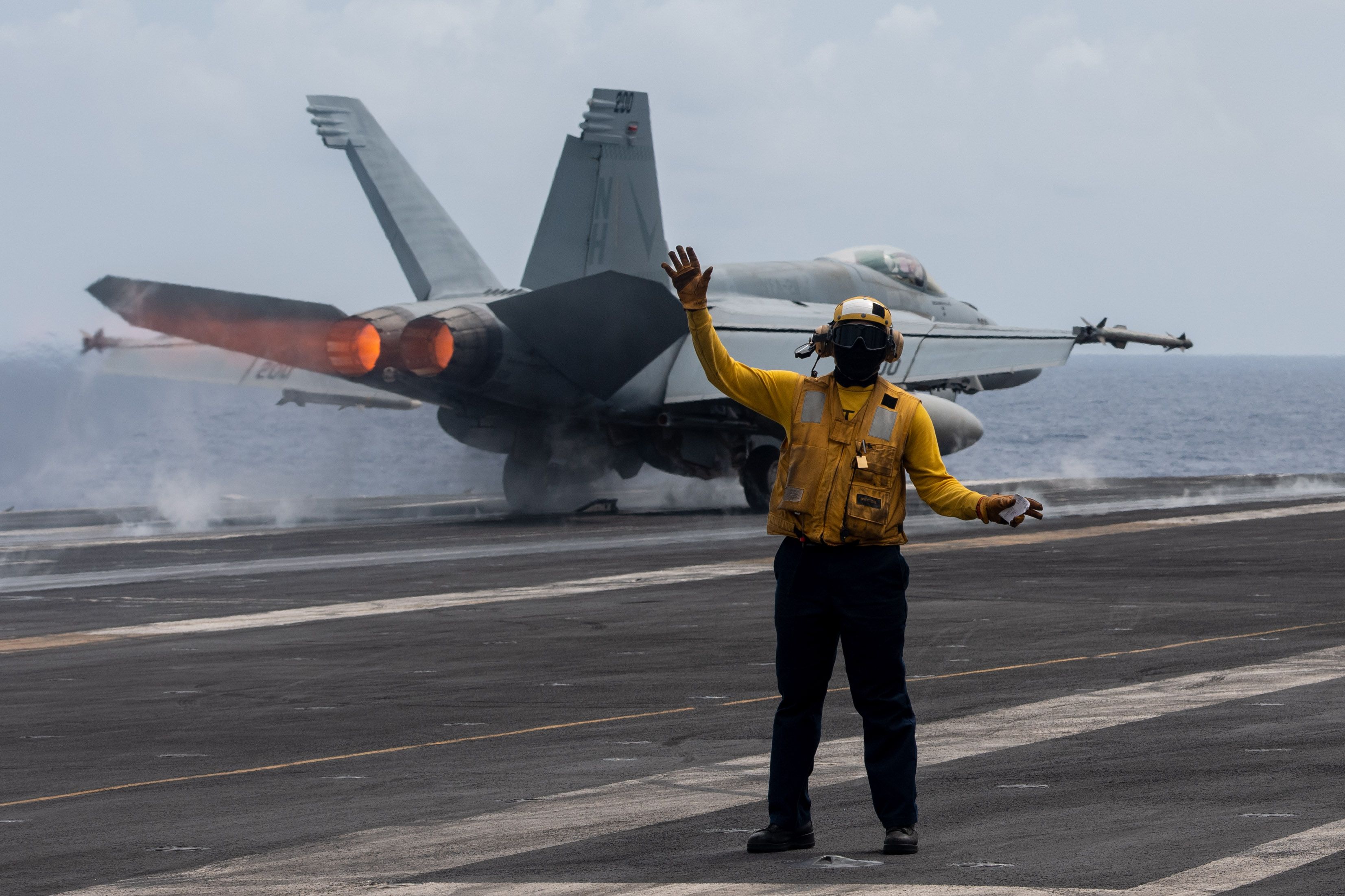 an F/A-18E Super Hornet assigned to the “Flying Checkmates” of Strike Fighter Squadron (VFA) 211 takes off from the flight deck aboard the Nimitz-class aircraft carrier USS Theodore Roosevelt