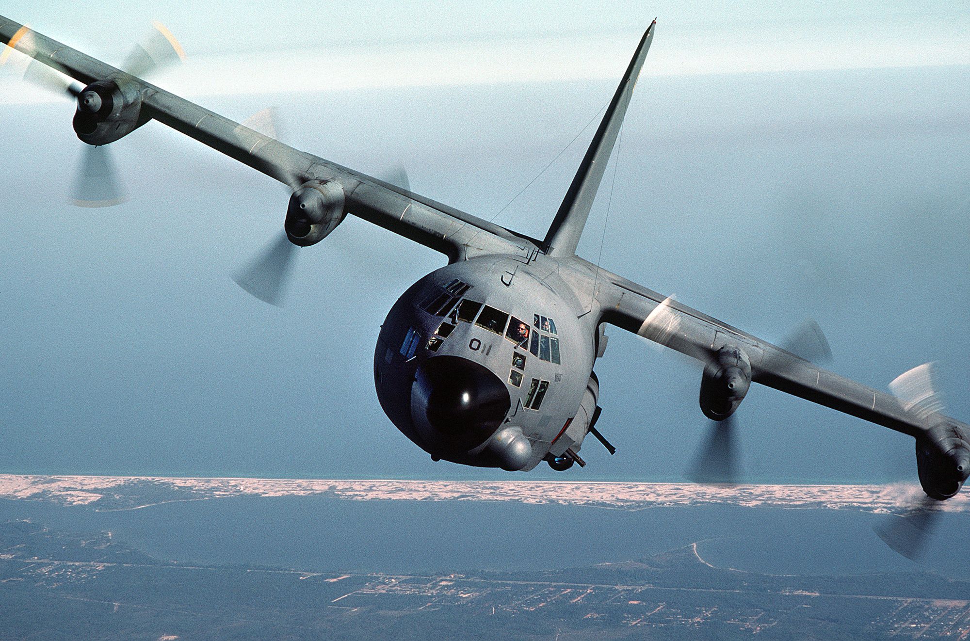 A Lockheed AC-130 flying in the sky.