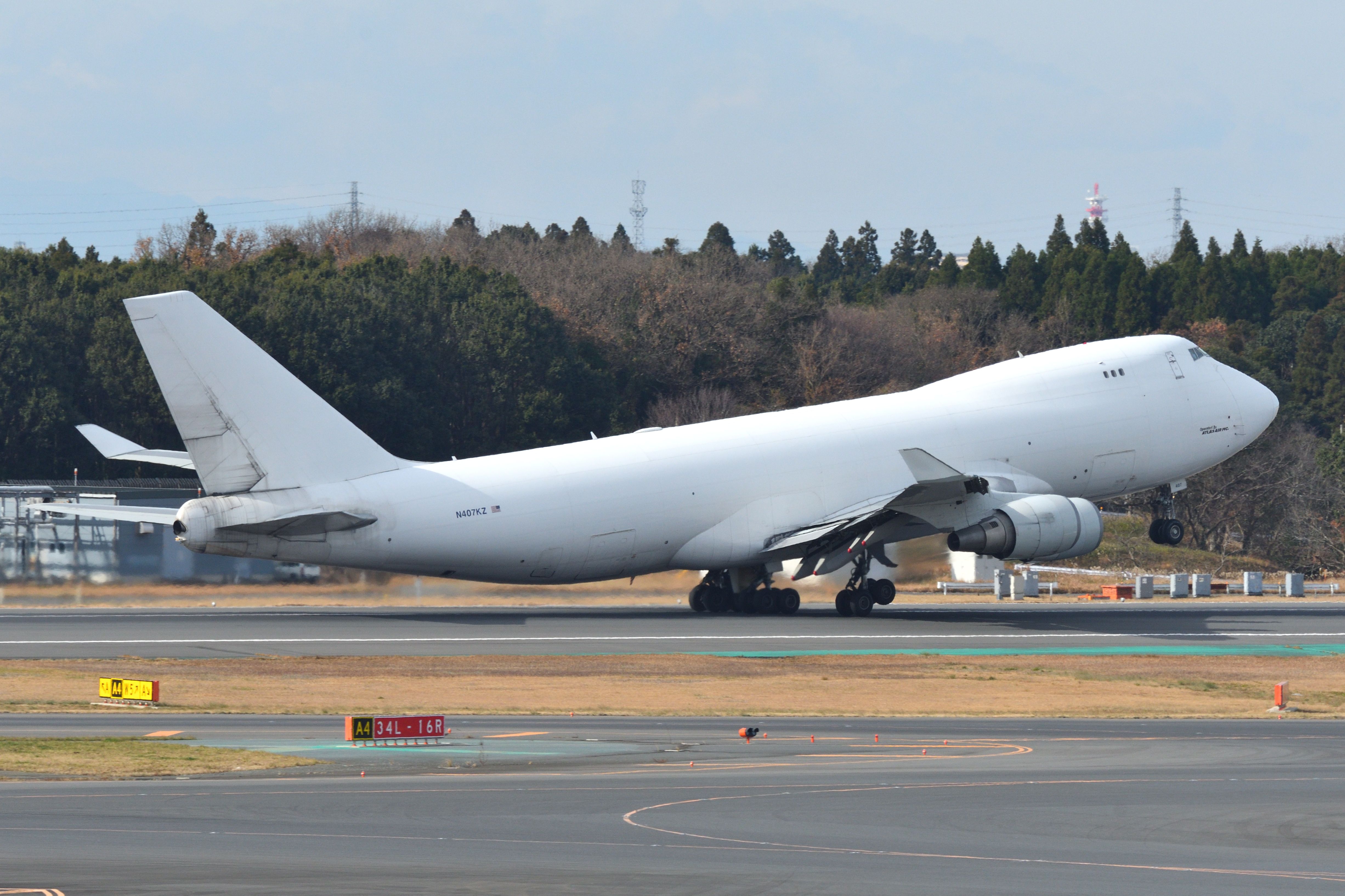 All-white Boeing 747-400F departing Japan shutterstock_1886249710
