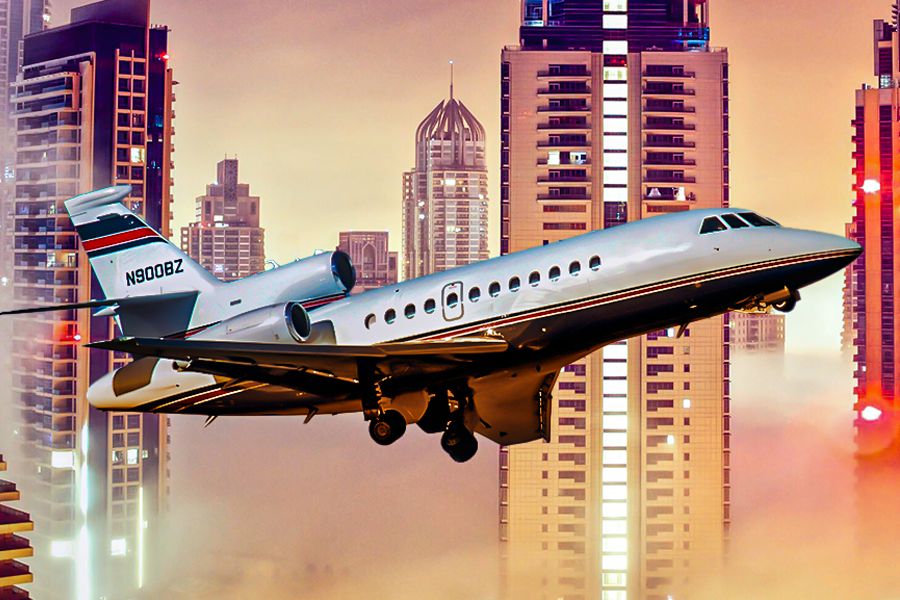 A Dassault Falcon 900 with skyscrapers in the background.