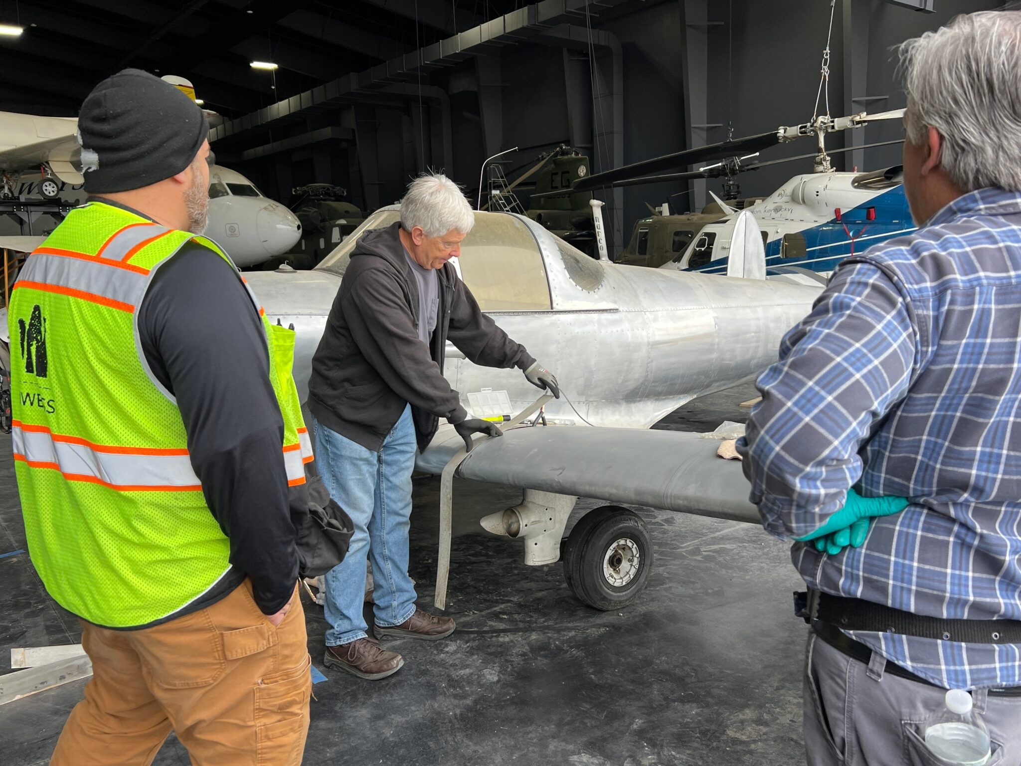 Brett Ebert [center] and American Airlines volunteers reassembled the Ercoupe so it could be suspended from the ceiling where it will be on display when the museum reopens.