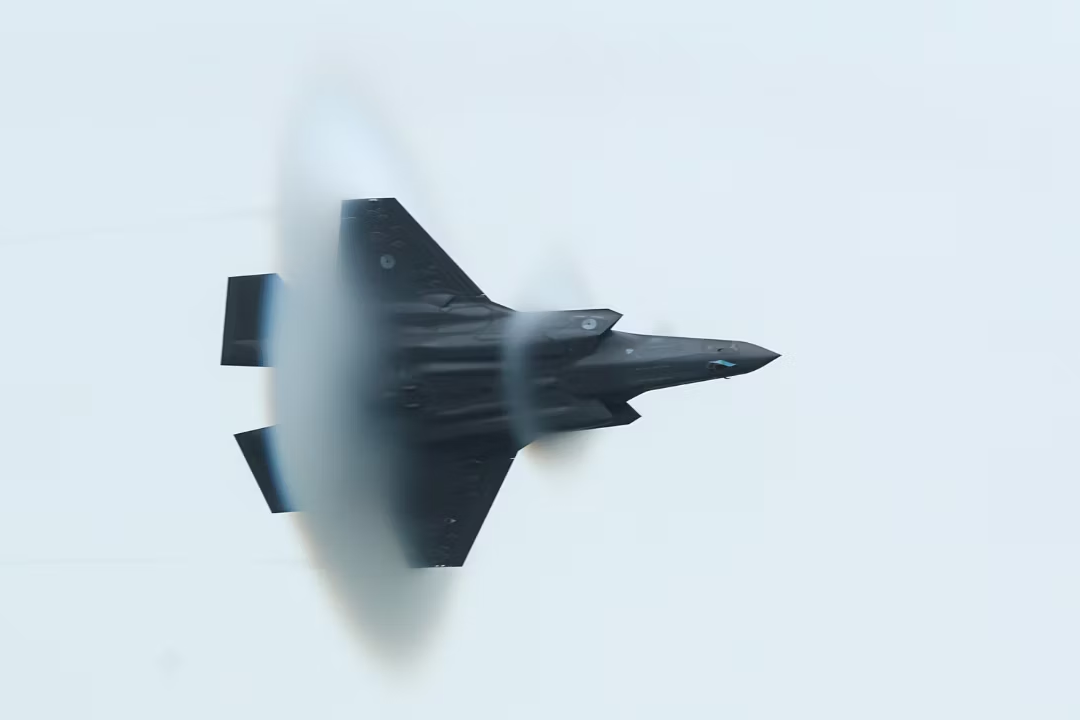 A Lockheed Martin F-35A Lightning II in the sky causing a sonic boom. 