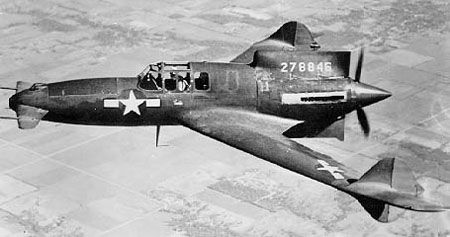 A Curtis XP-55-CS Ascender flying above a desert.