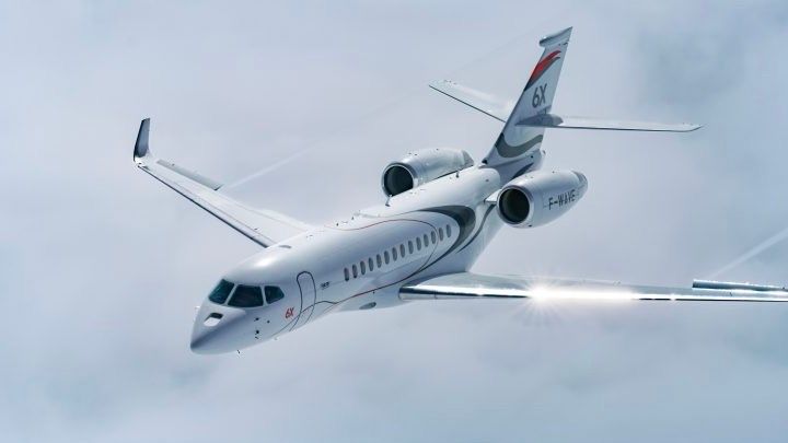 A Dassault Falcon 6X flying in the sky.