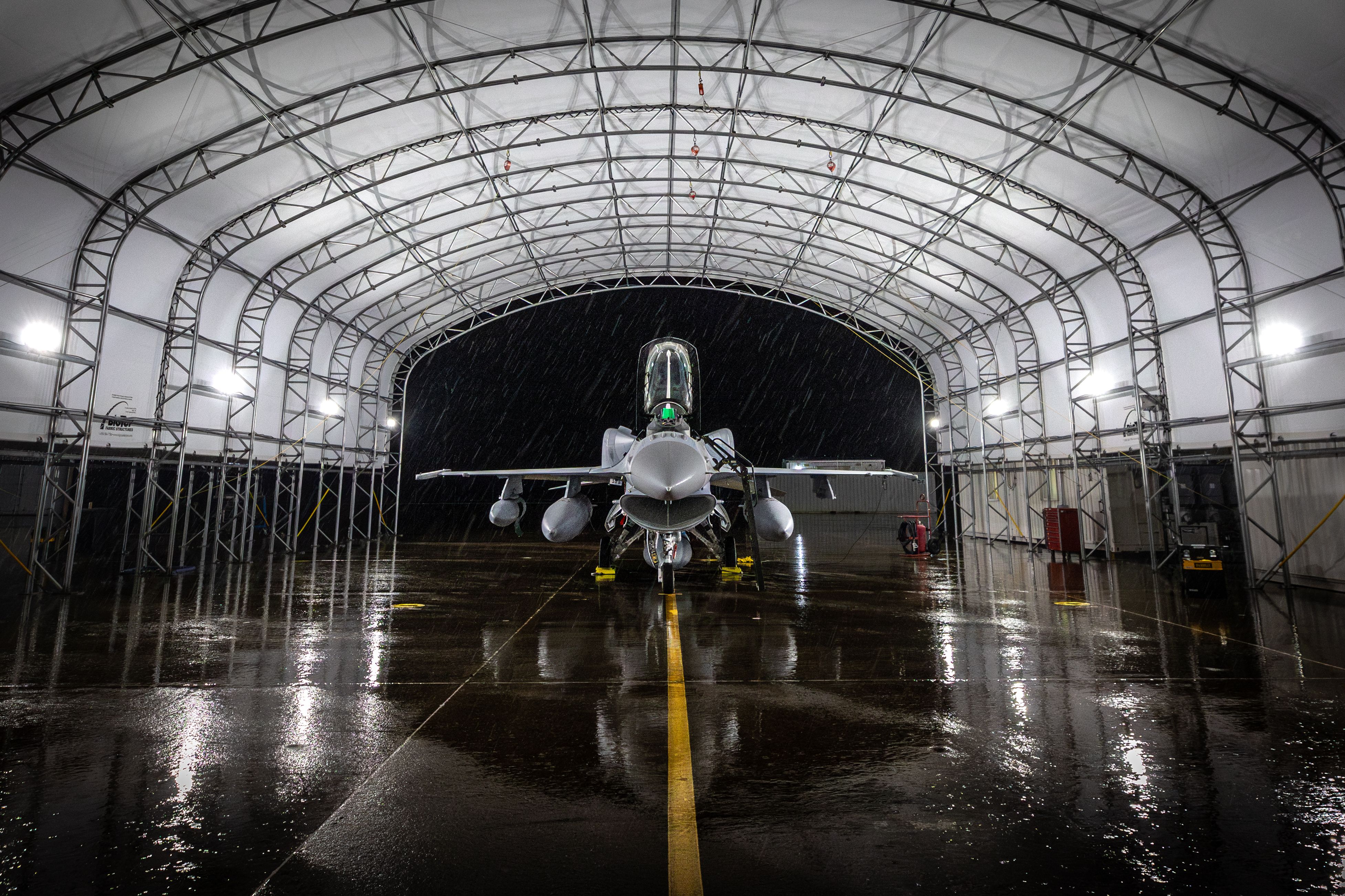 An F-16 Block 70 parked in a hangar.