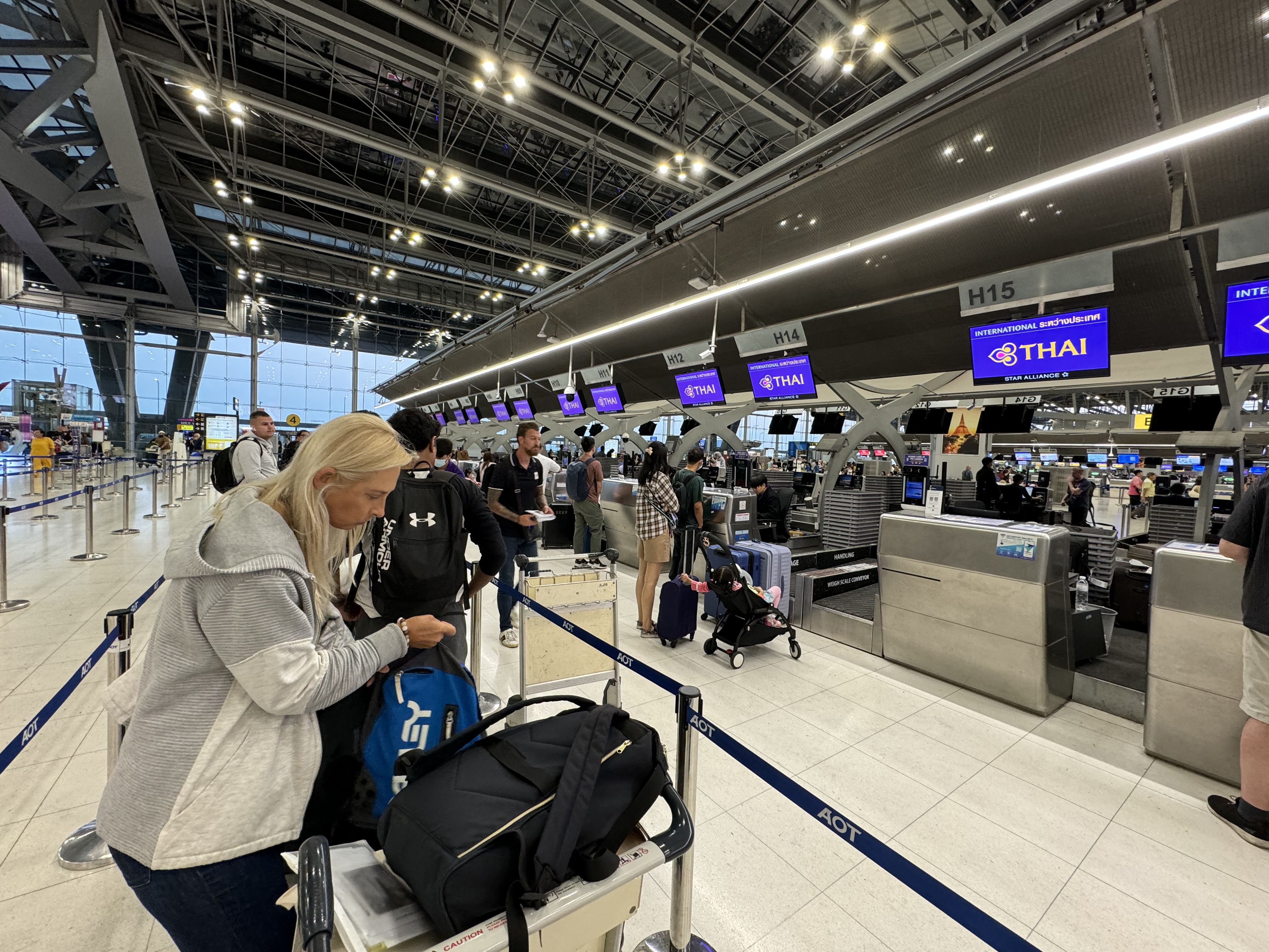 Pasengers waiting in line to check into a flght at Bangkok Suvarnabhumi Airport.