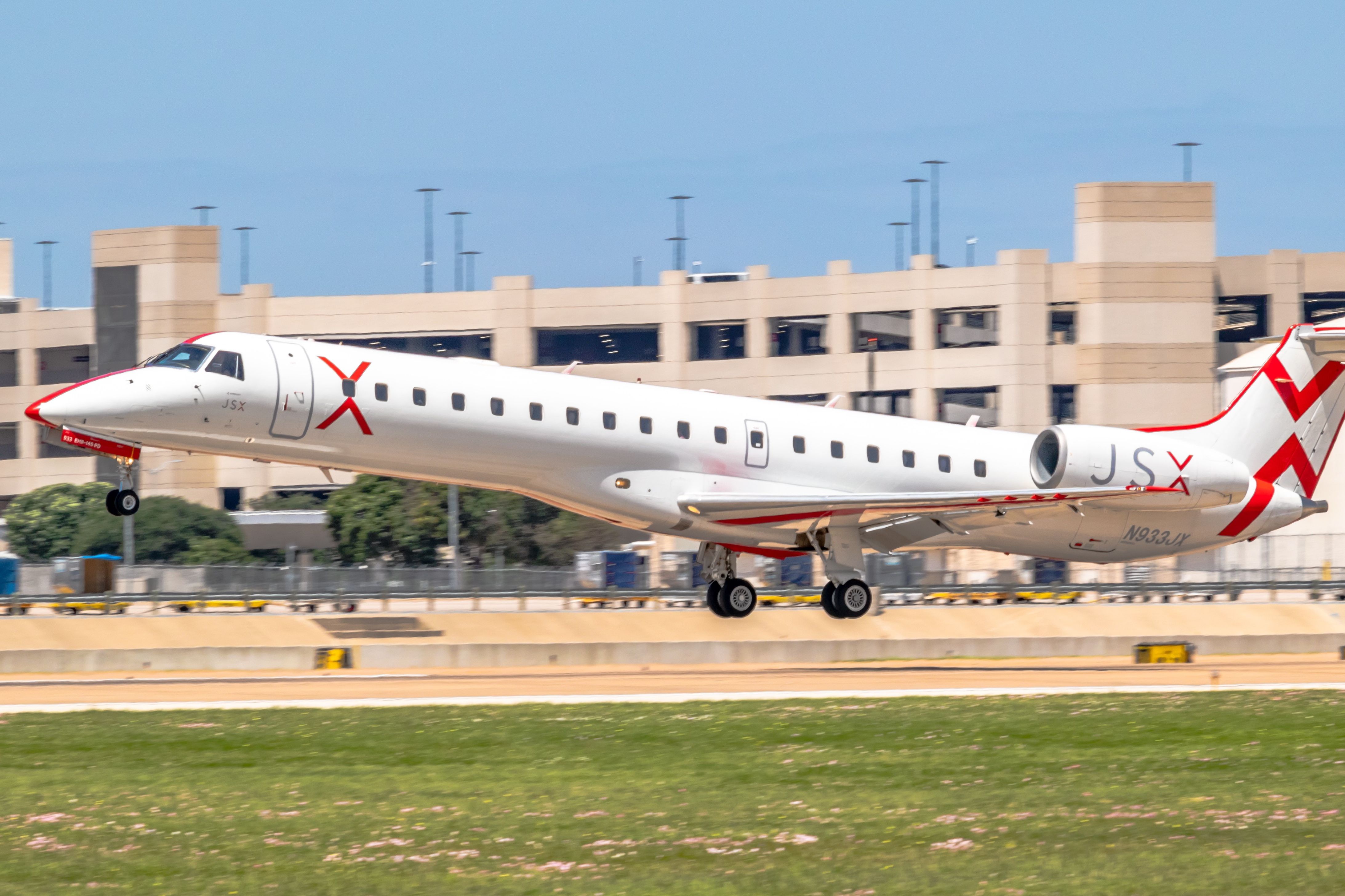 A JSX aircraft just above a runway.