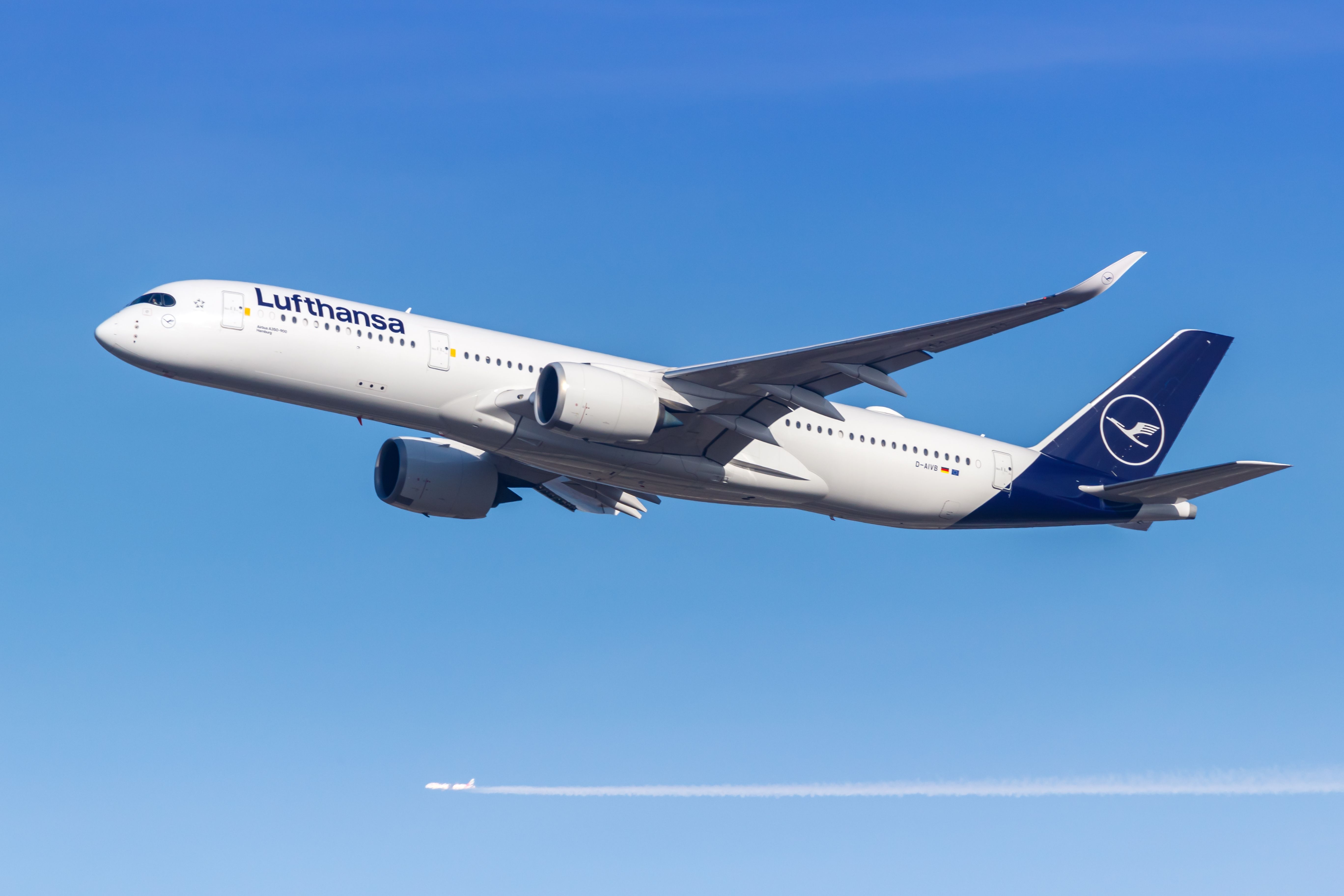 A Lufthansa Airbus A350-900 flying in the sky.