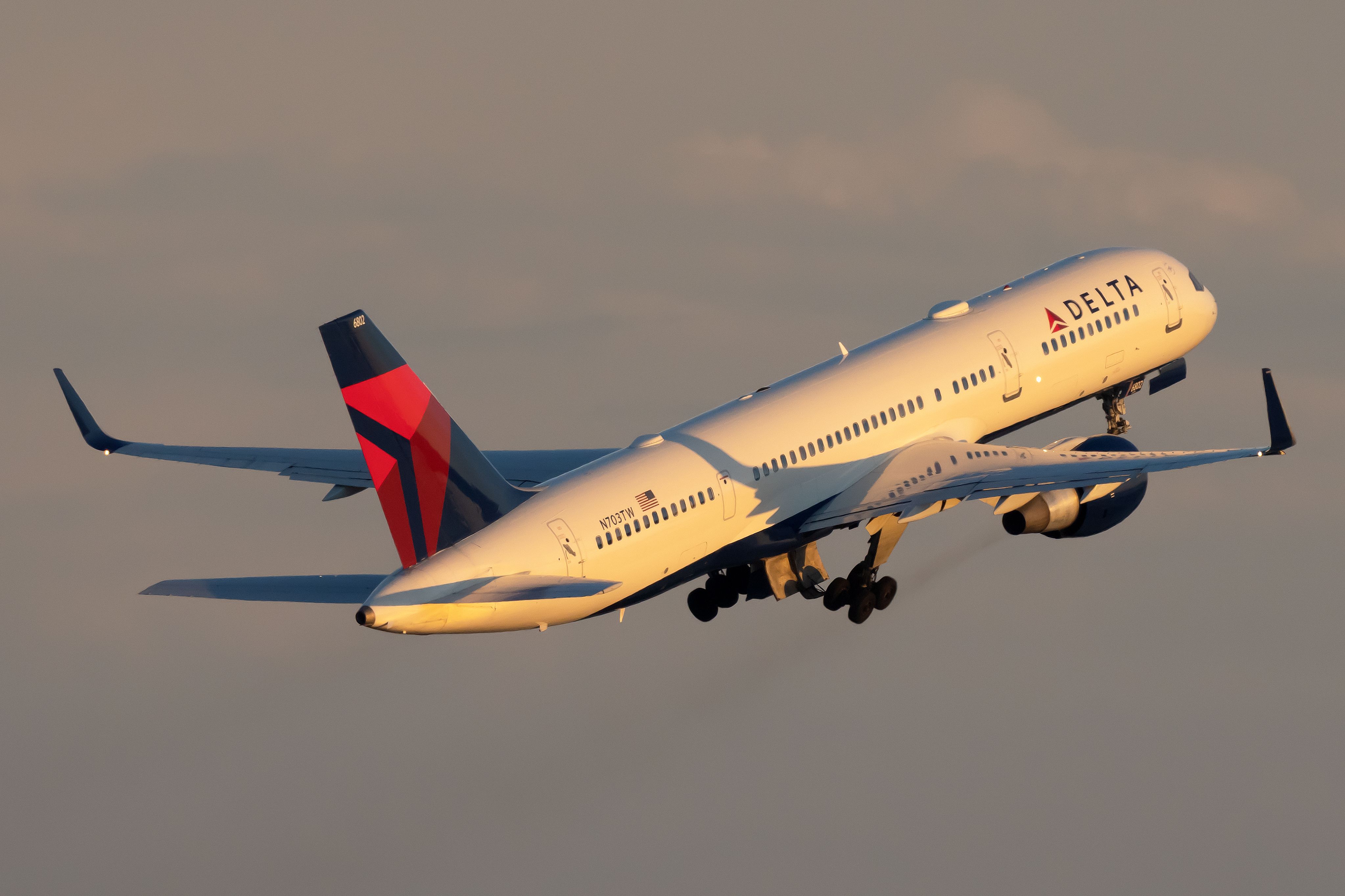 A Delta Air Lines Boeing 757 flying in the sky.