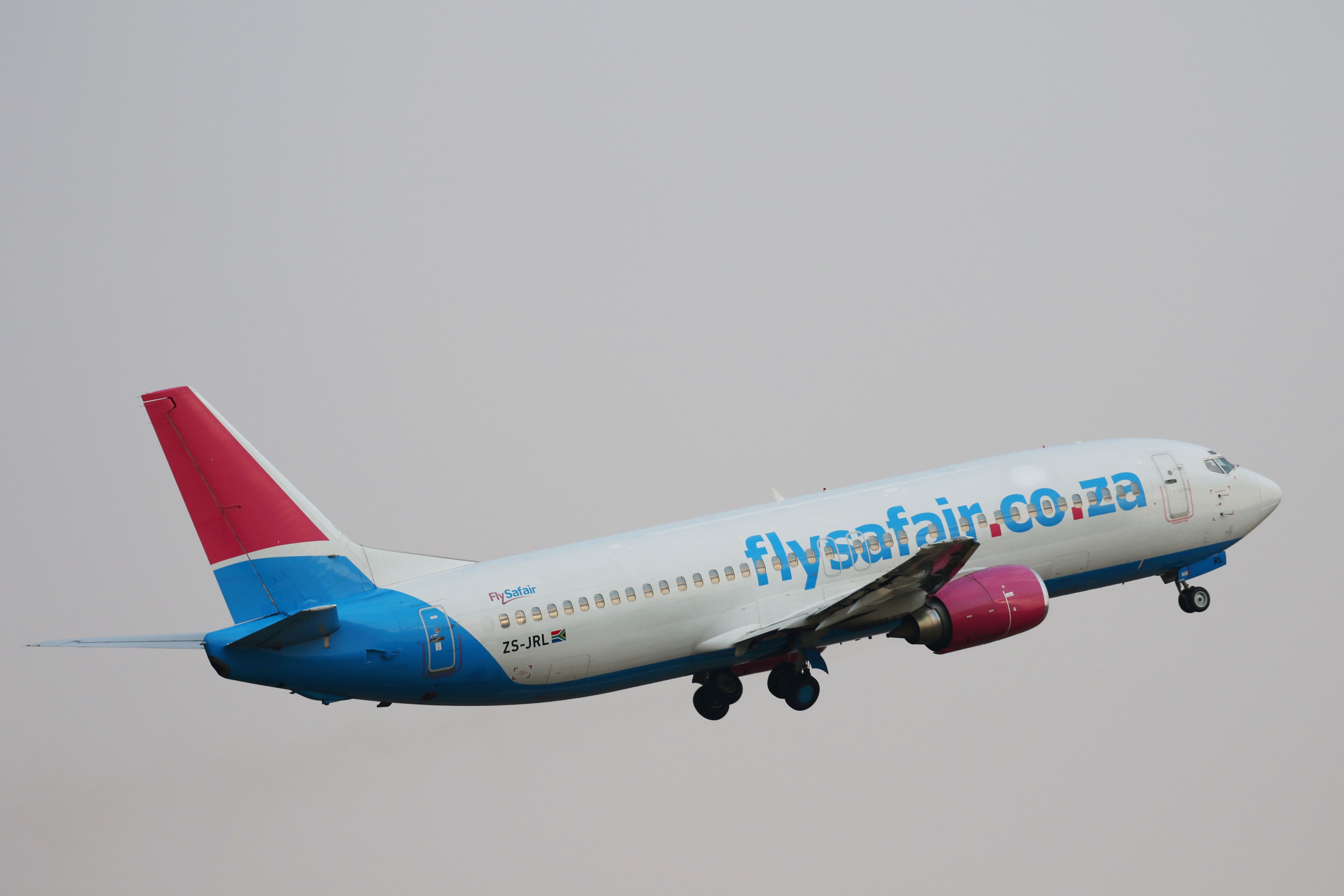 A Flysafair aircraft flying in the sky.