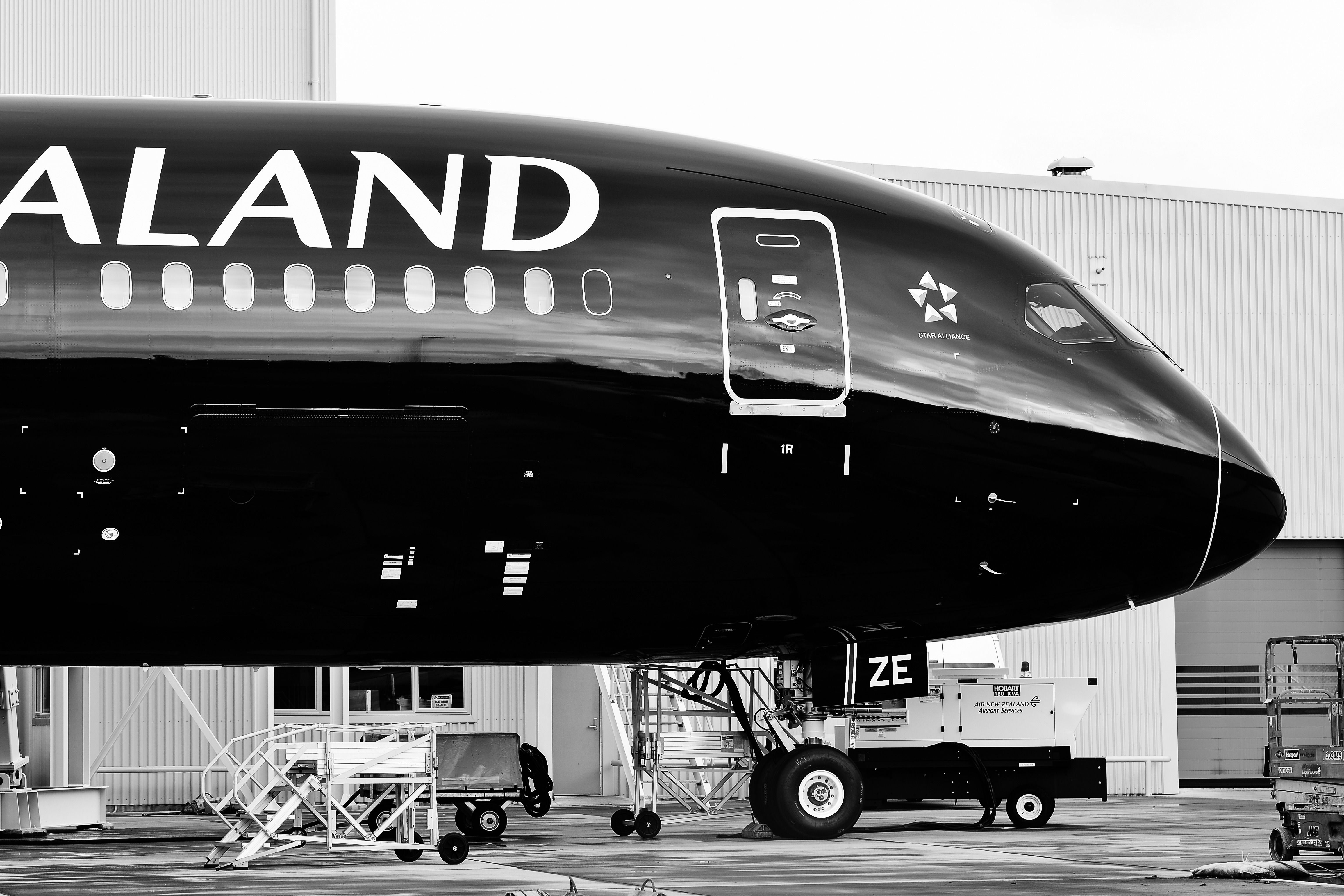 A Closeup of the nose of an Air New Zealand Boeing 787 parked on an airport apron.