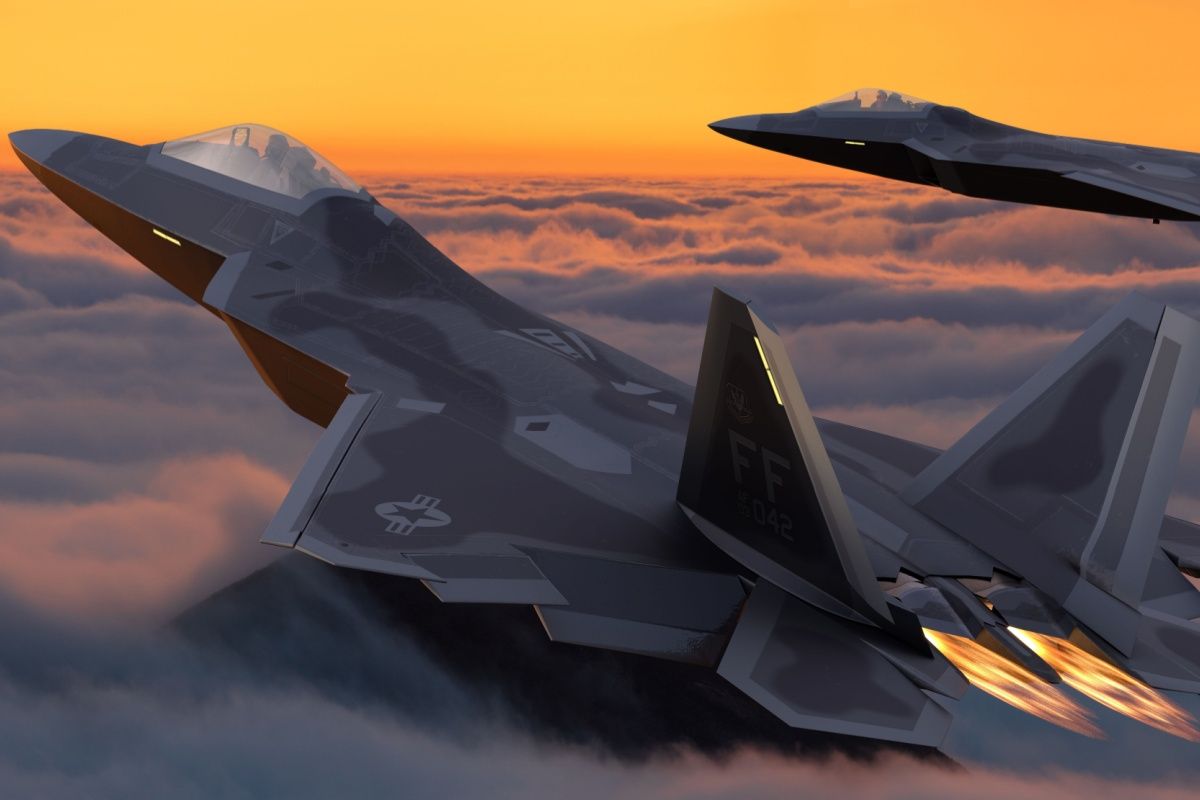 Two Lockheed Martin F-22 Raptors flying above the clouds.