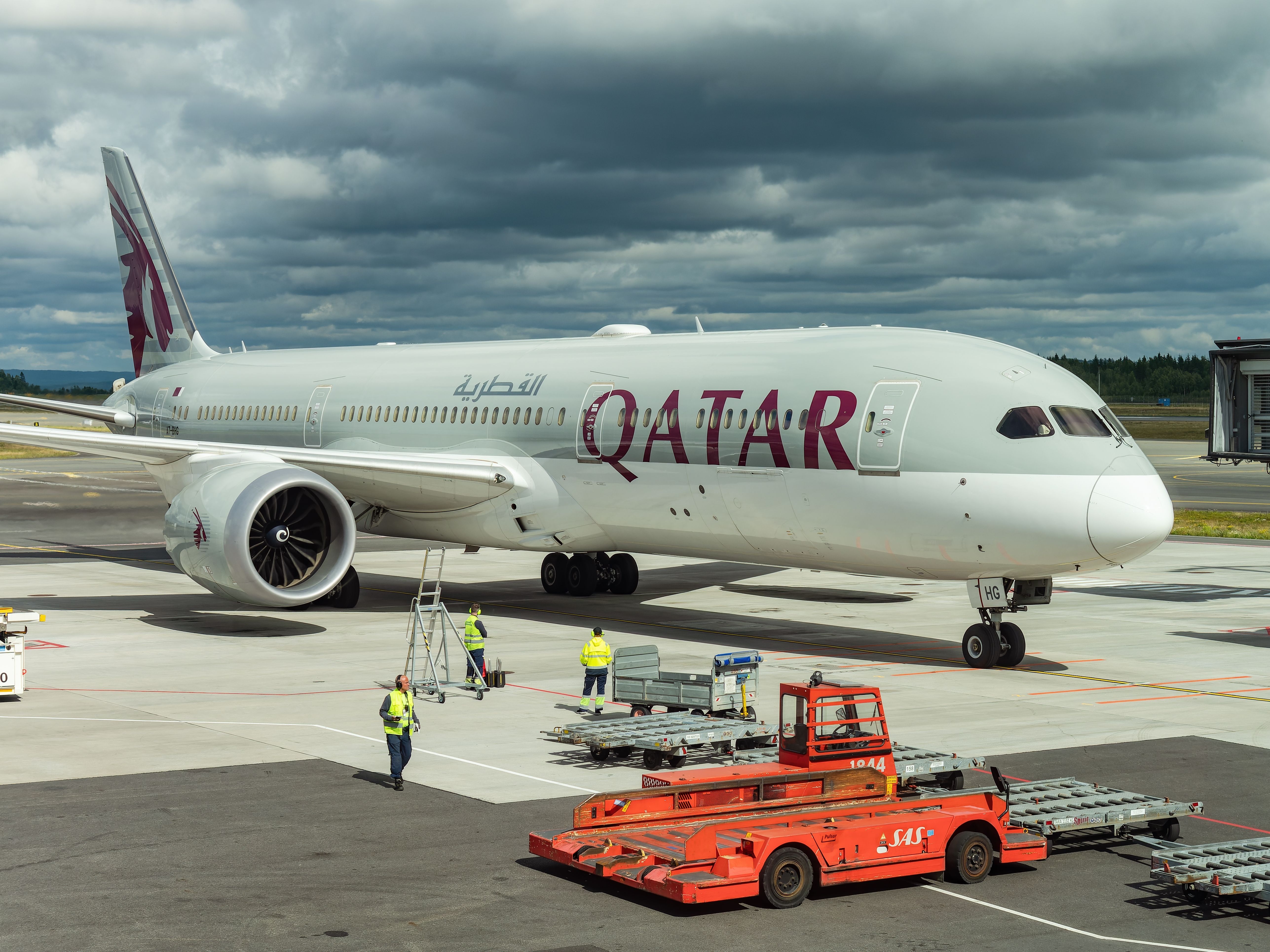 A Qatar Airways Boeing 787-9 on an airport apron.