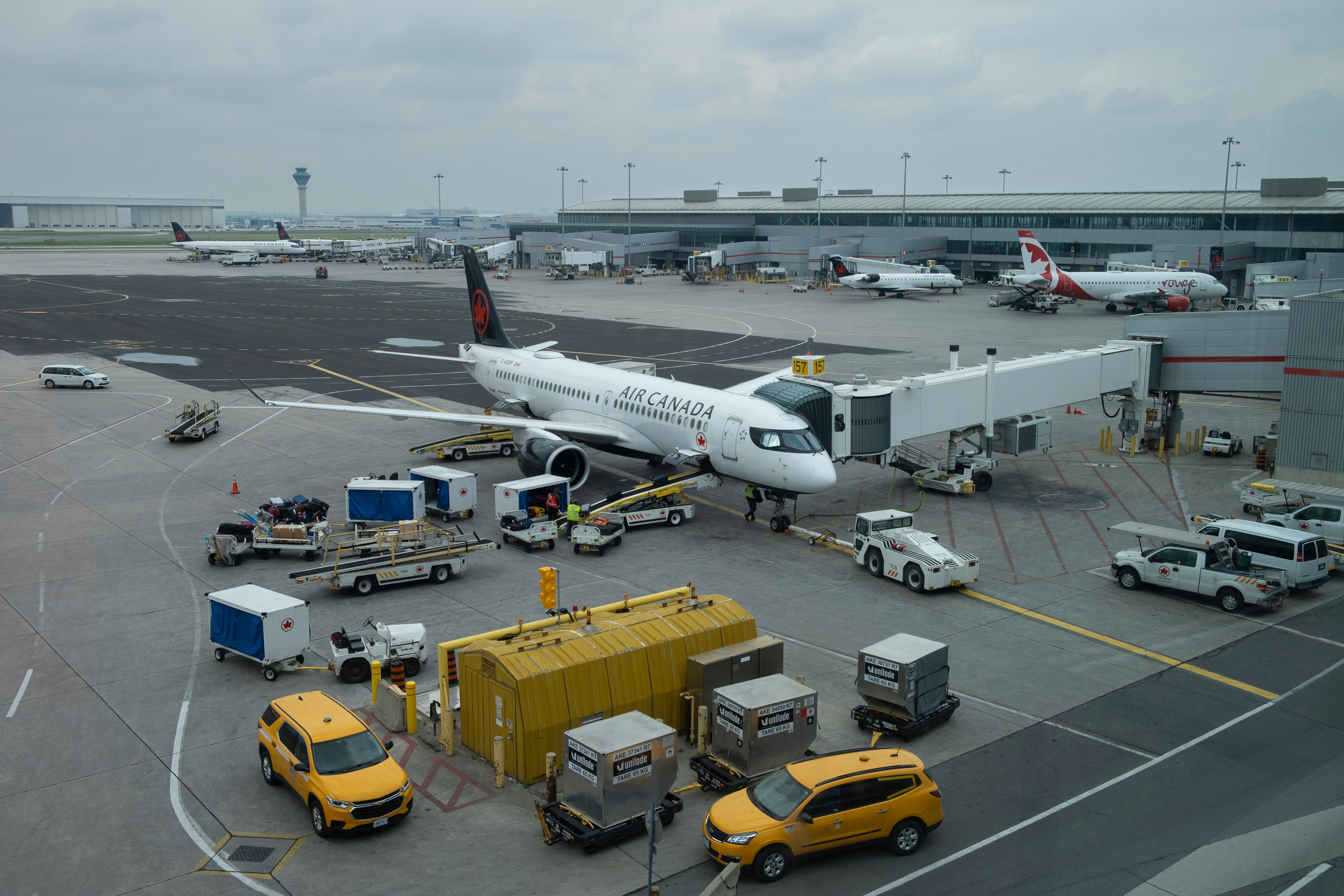 Air Canada on apron with ground vehicles