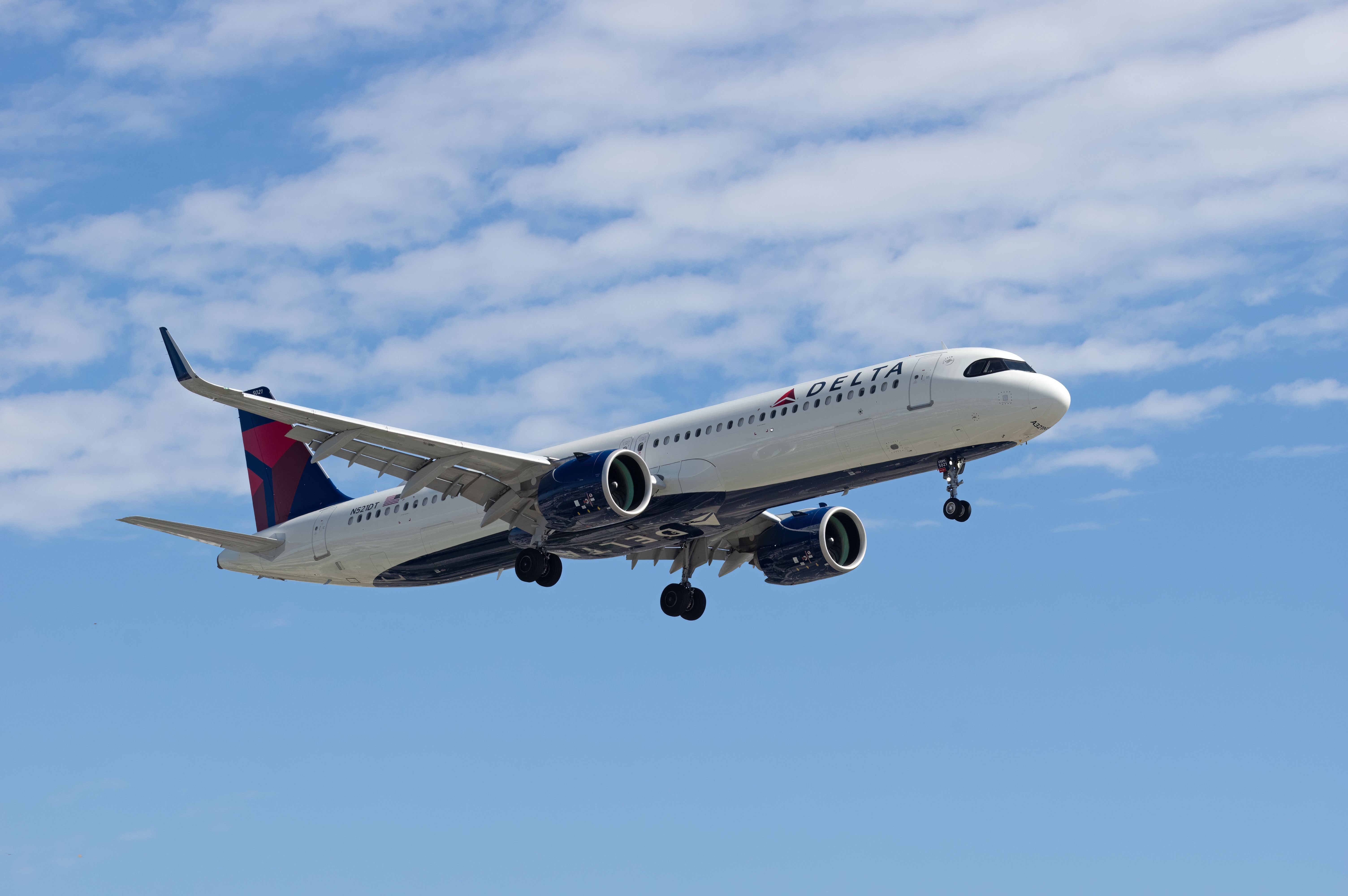 A Delta Air Lines Airbus A321neo flying in the sky.