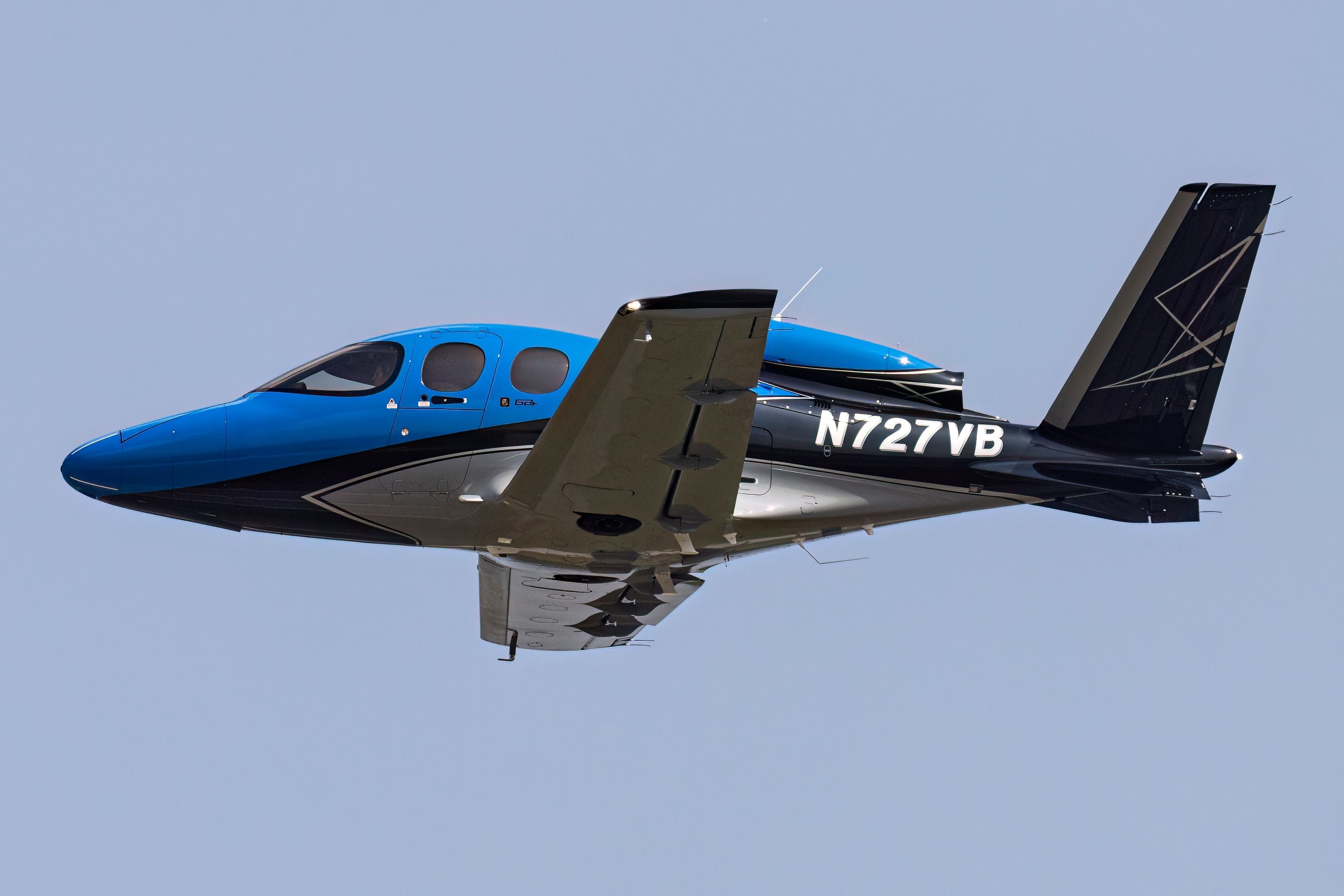 A Cirrus G2+ Vision Jet flying in the sky.