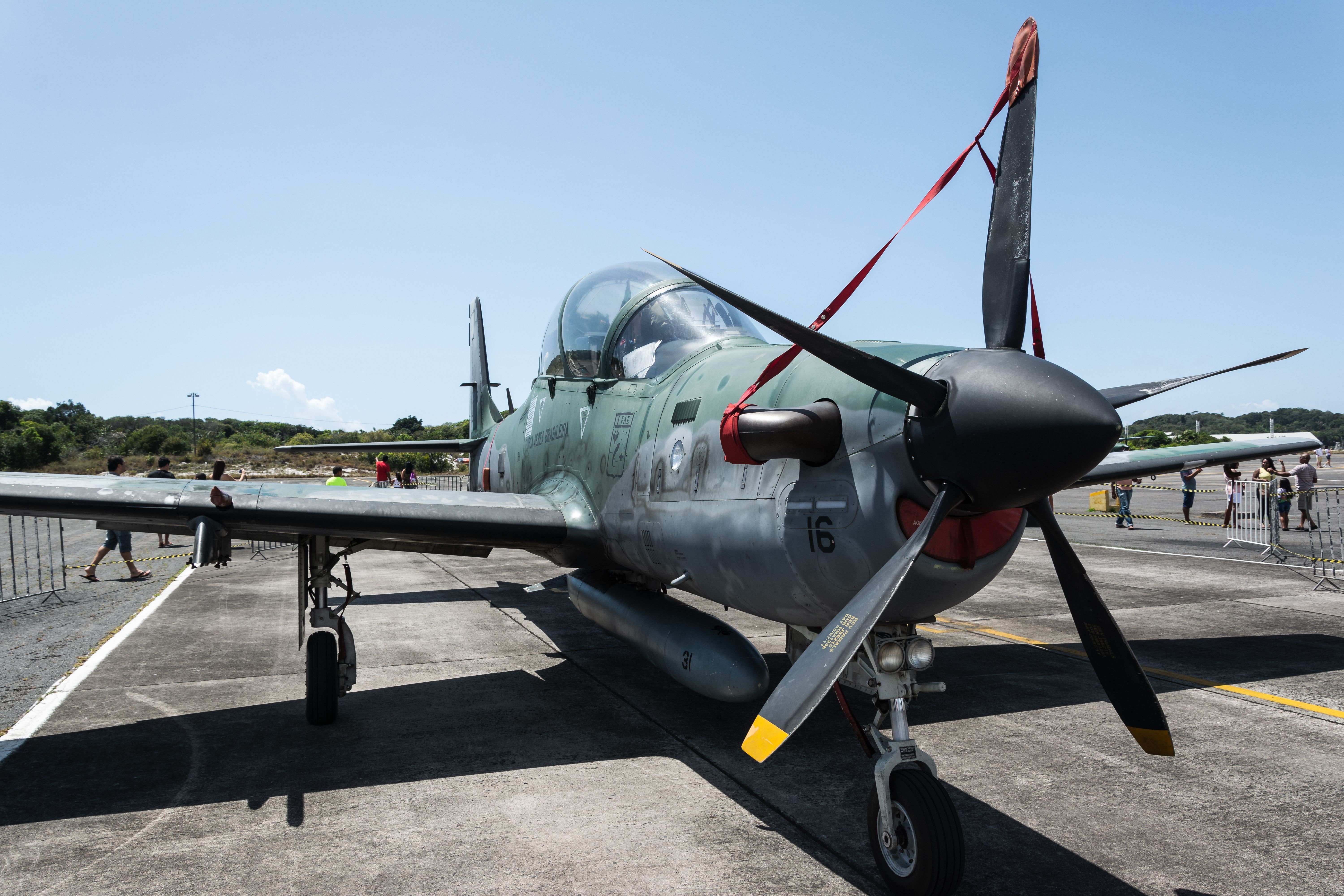 An Embraer A-29 Super Tucano parked on an airfield. 