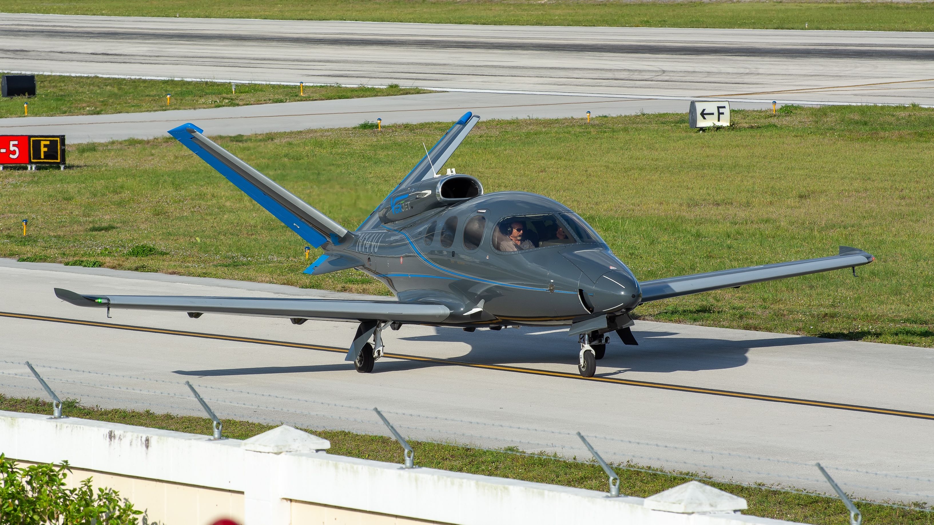 A Cirrus Vision jet on an airport apron.