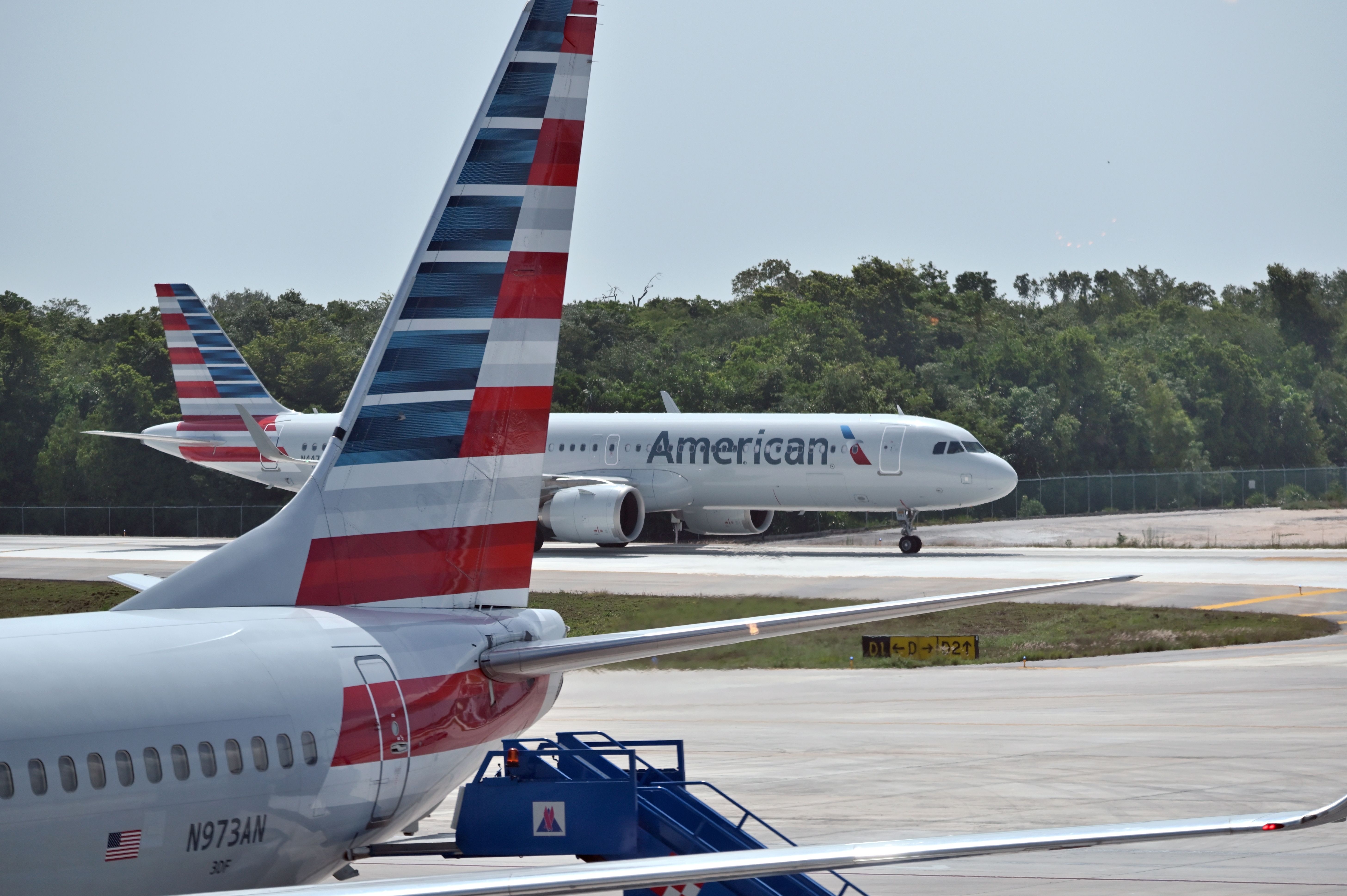 An American Airlines Boeing 737-800 and Airbus A321neo on an airport apron.