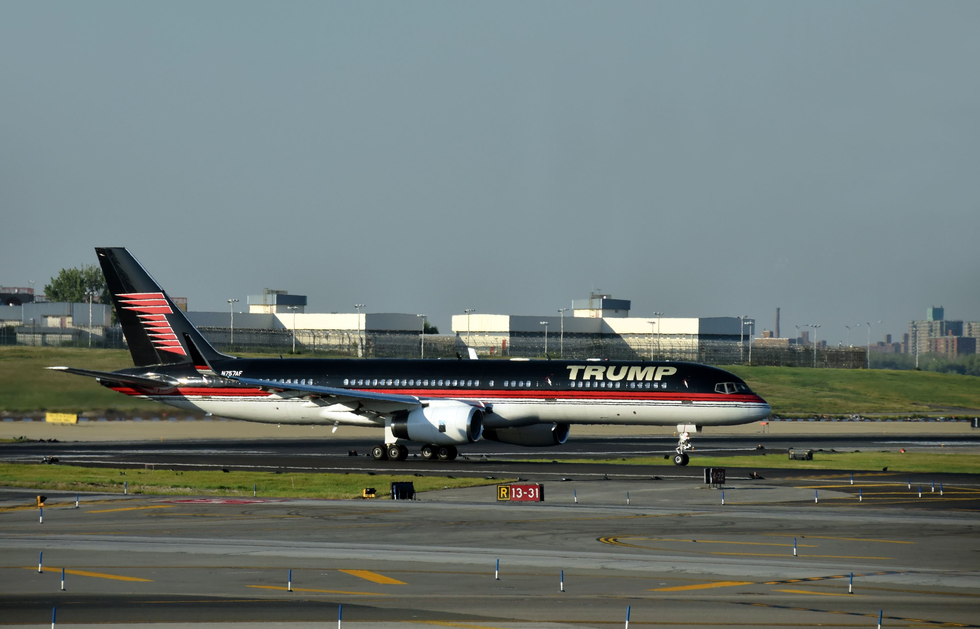 Boeing 757 jet airplane bearing the logo of Donald Trump takes off from laguardia, New York City