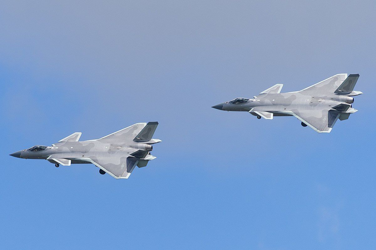 Two J-20 fighter jets flying in the sky.