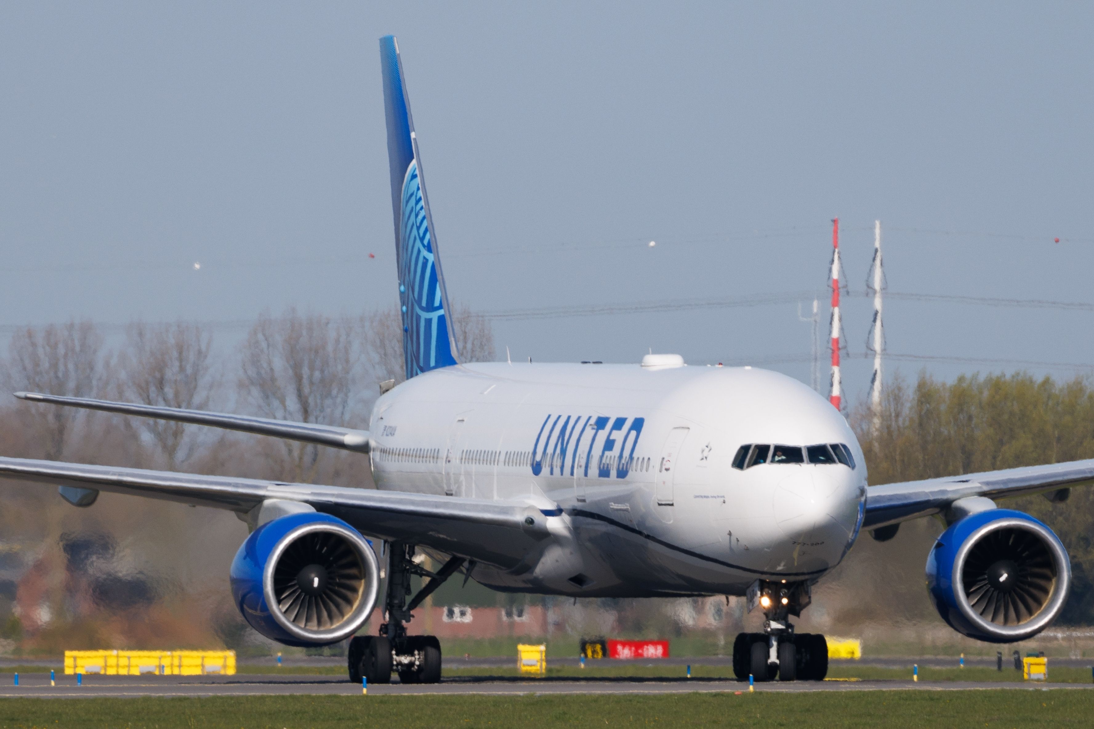 A United Airlines Boeing 777 on the apron at Amsterdam Schiphol Airport.