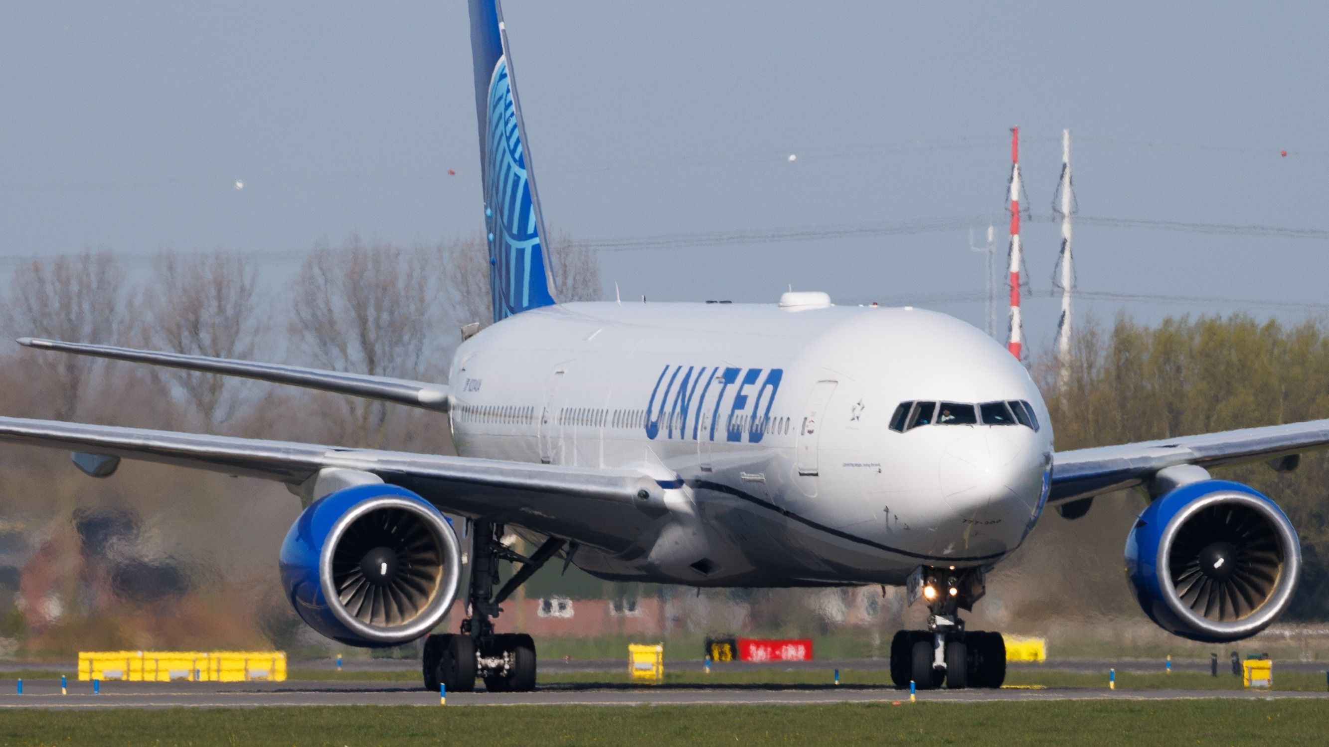 A United Airlines Boeing 777 on the apron at Amsterdam Schiphol Airport.