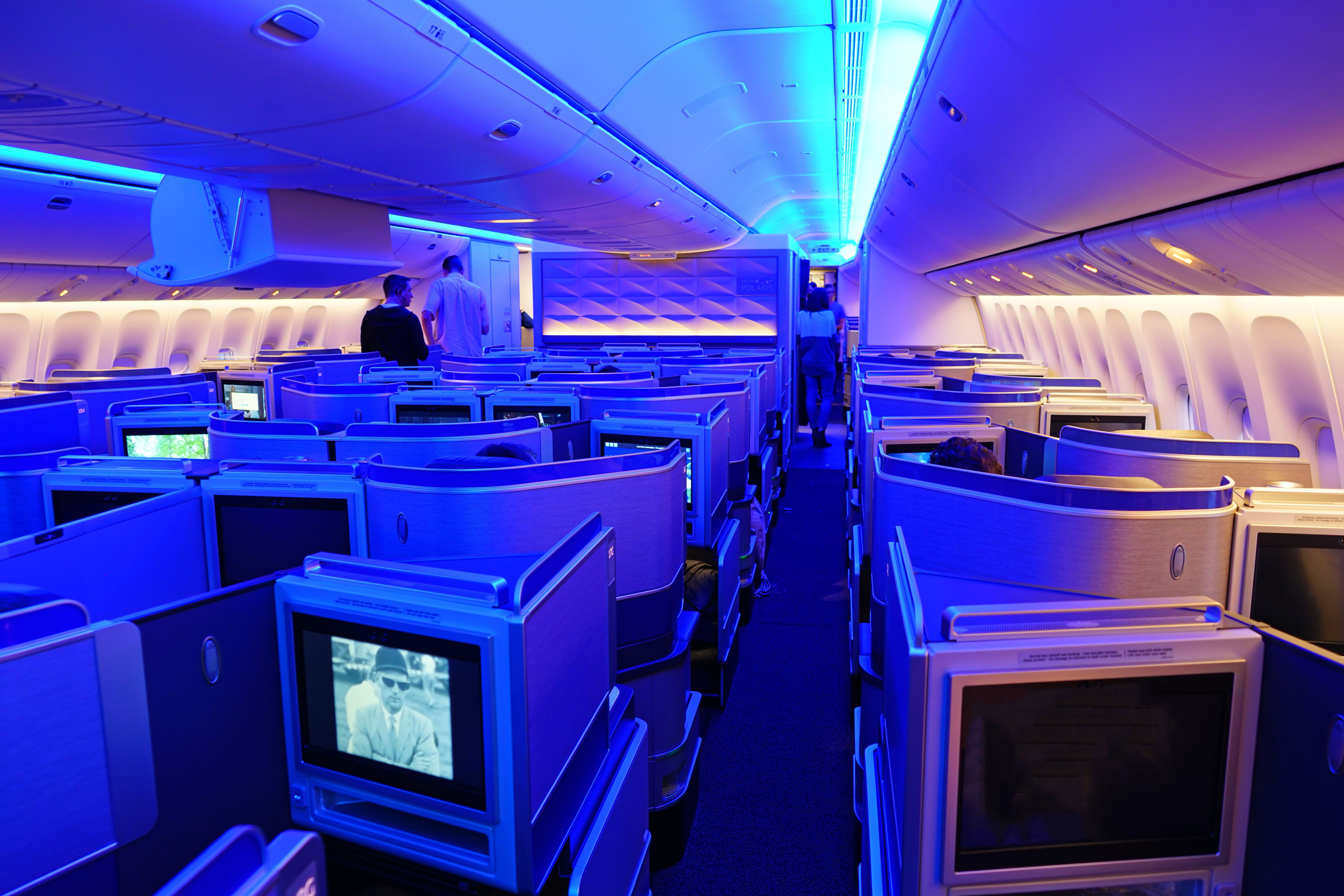 Inside the United Airlines Polaris Business Class cabin of a twin aisle aircraft.