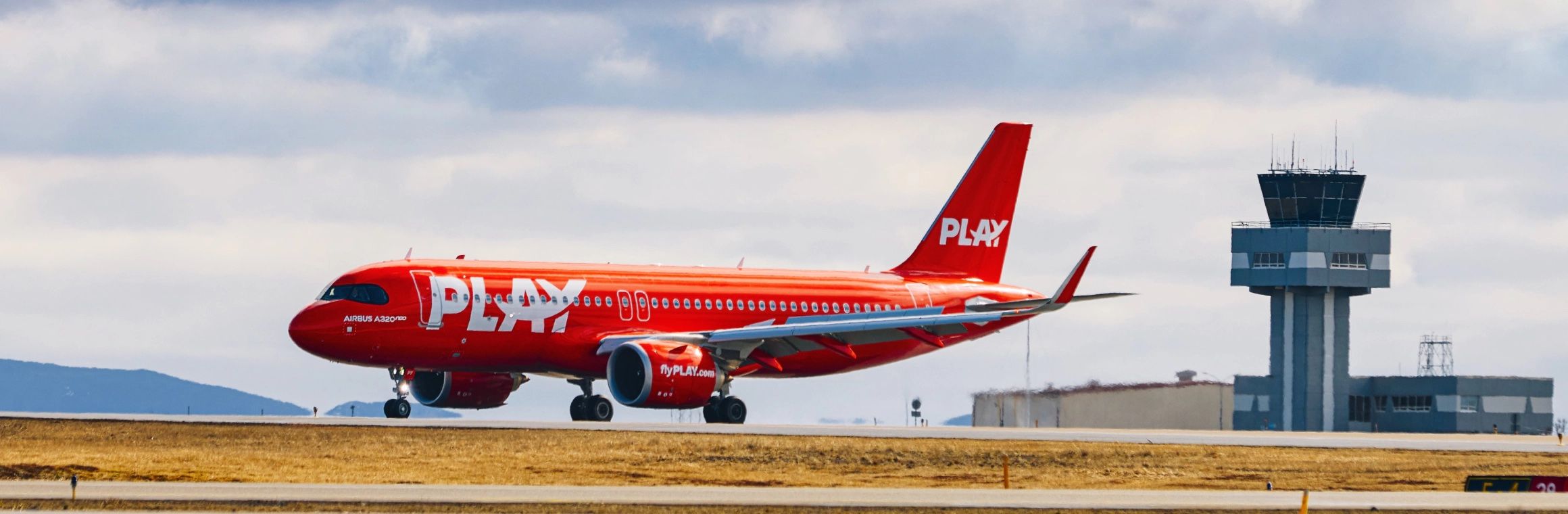 A PLAY aircraft on an airport apron.