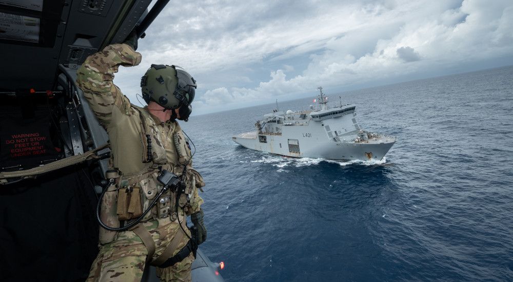 New Zealand Air Force helicopter and New Zealand warship