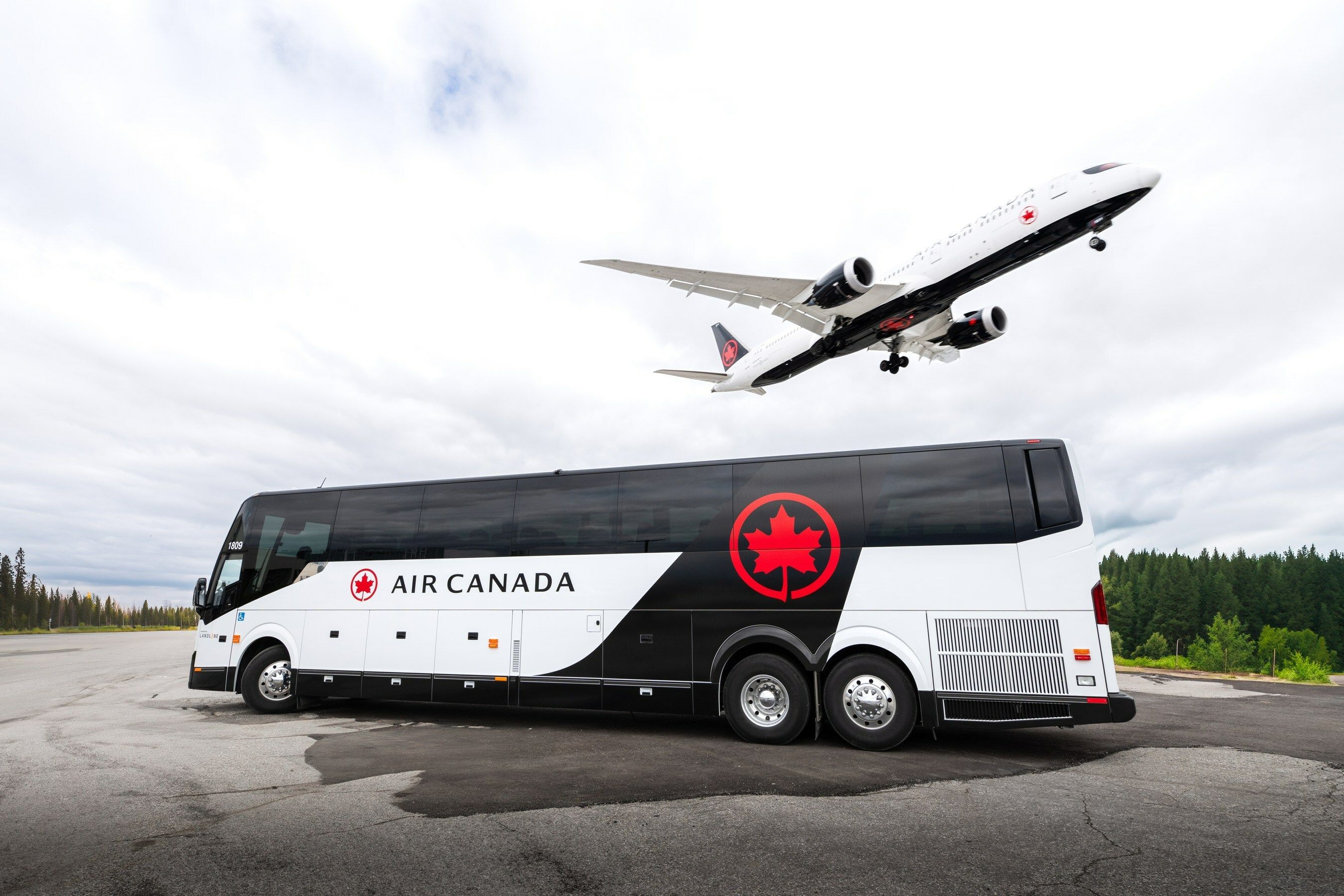 Air Canada Motorcoach With Aircraft Taking Off Overhead