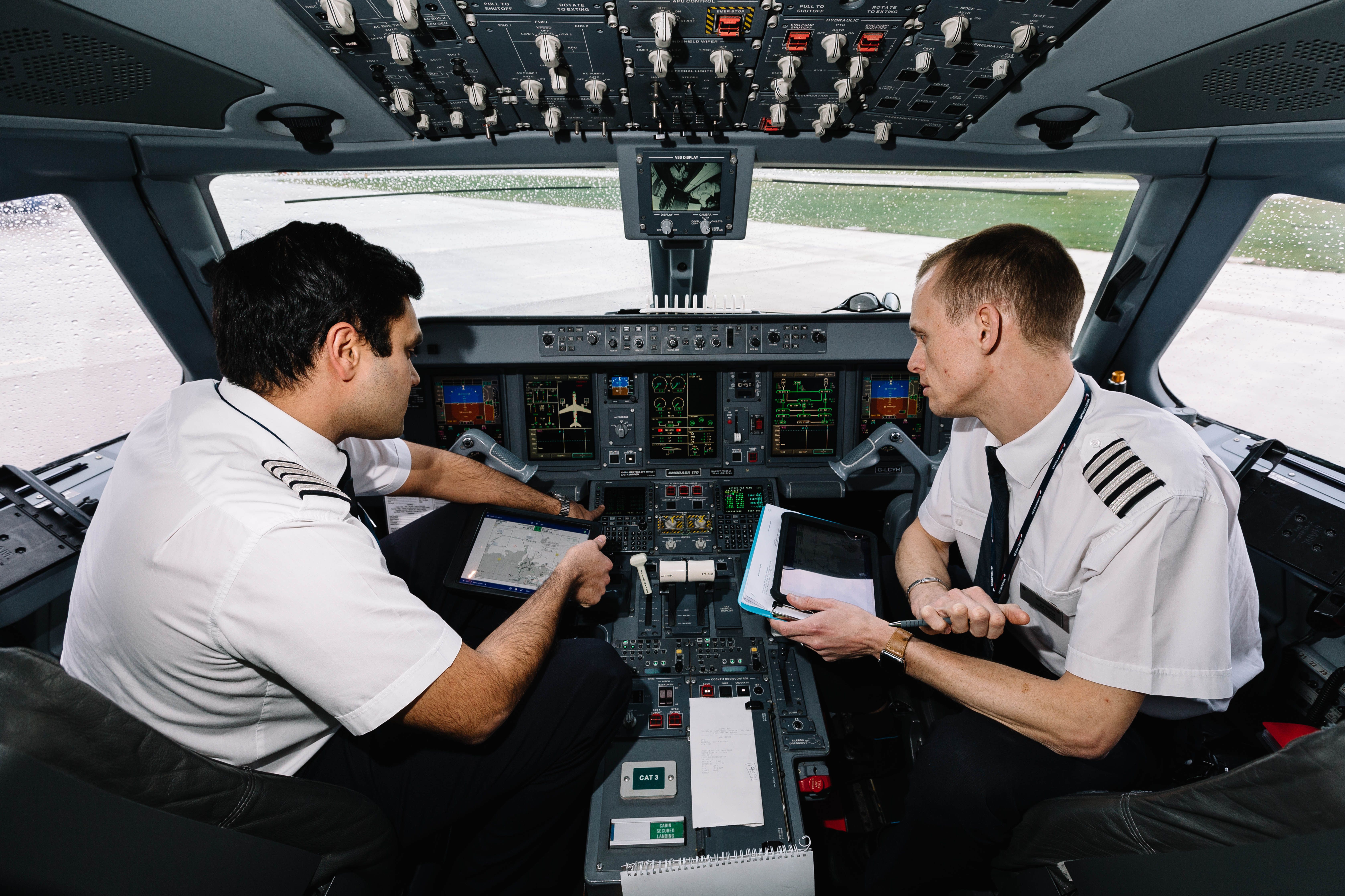 Pilots Consulting Materials In Cockpit