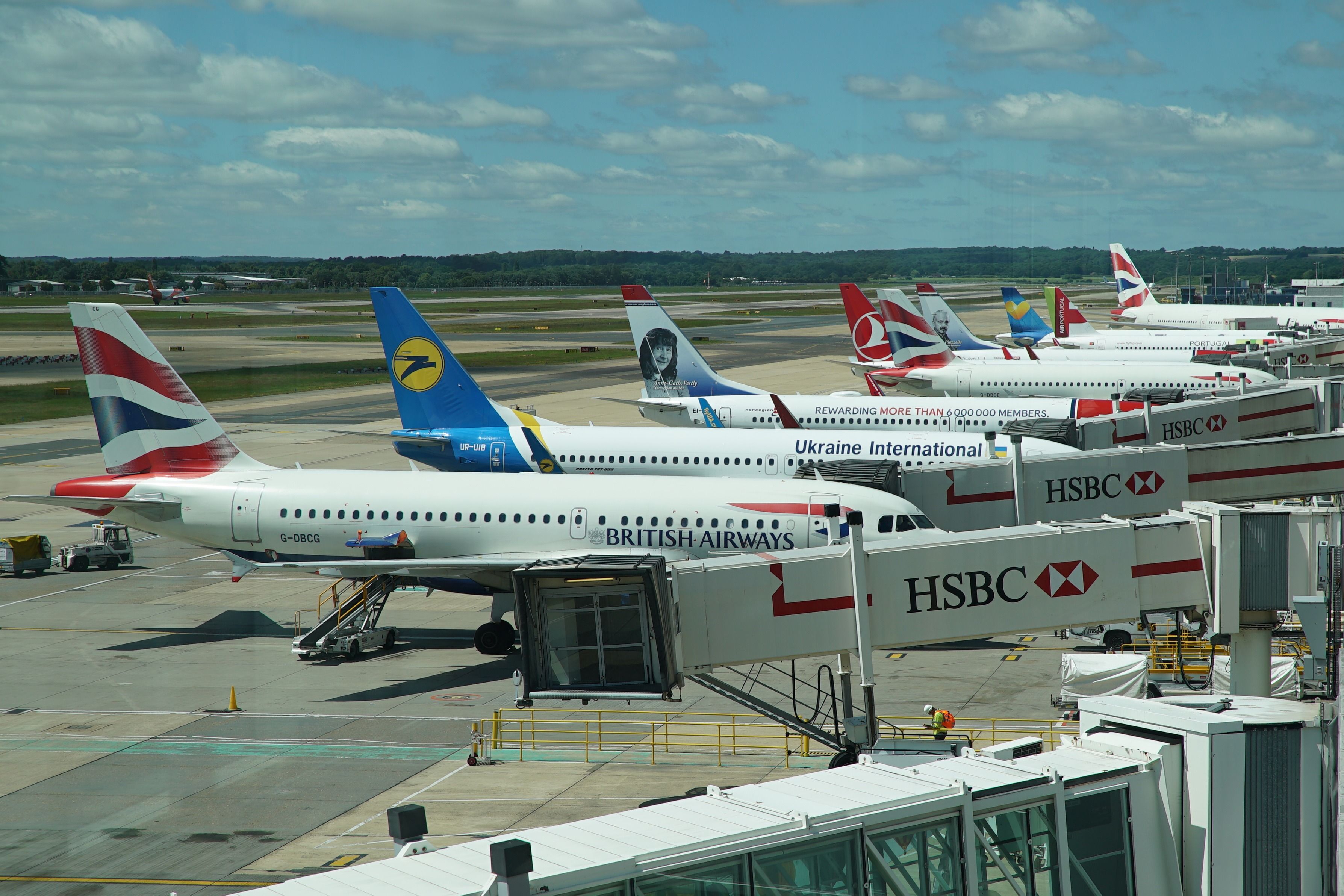 Aircraft parked at an airport with HSBC sponsored jetbridges