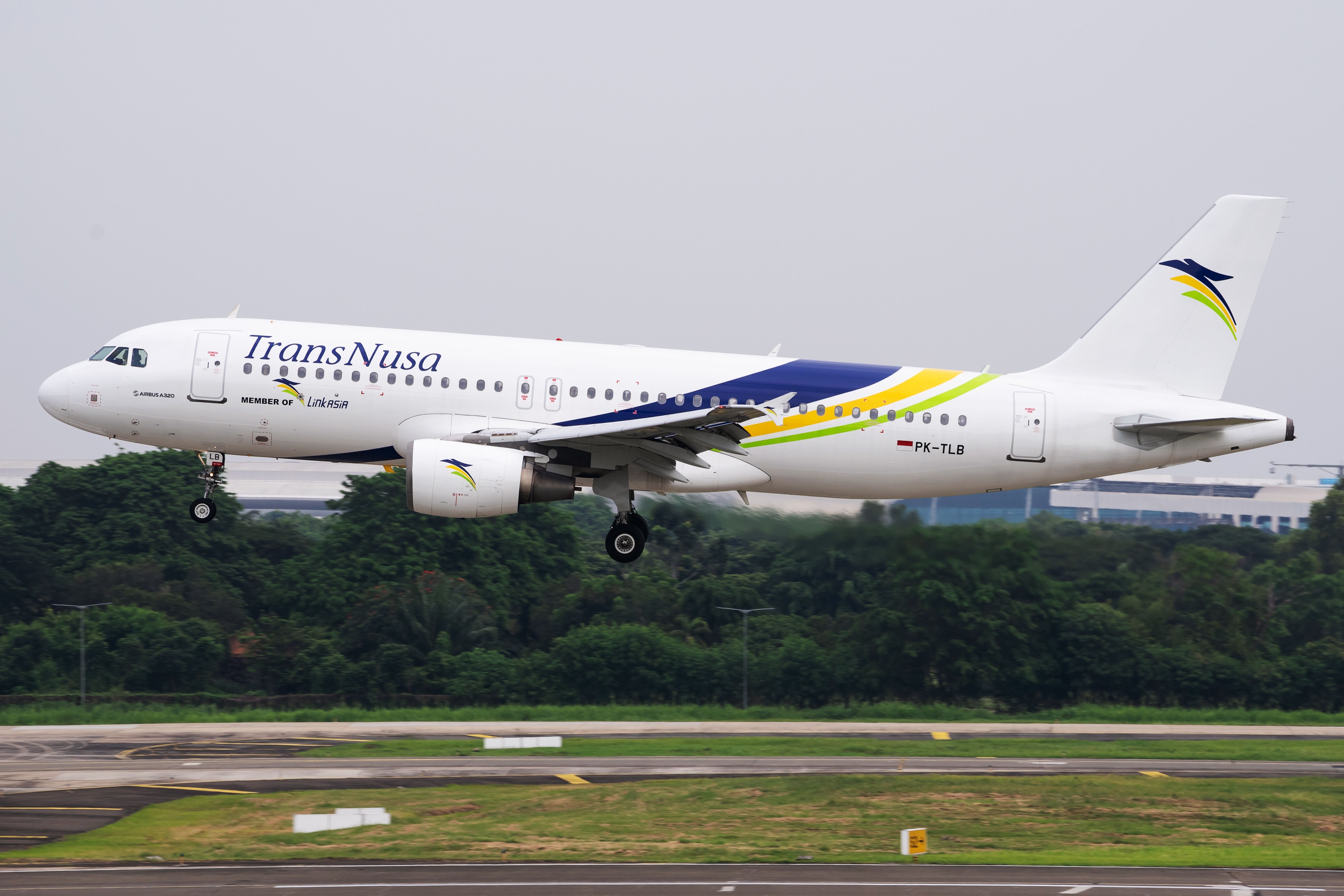 Tangerang, Banten: Indonesia-31 October 2022: TransNusa Airlines Airbus A320-200 (PK-TLB) landing on runway 25L at Soekarno-Hatta International Airport