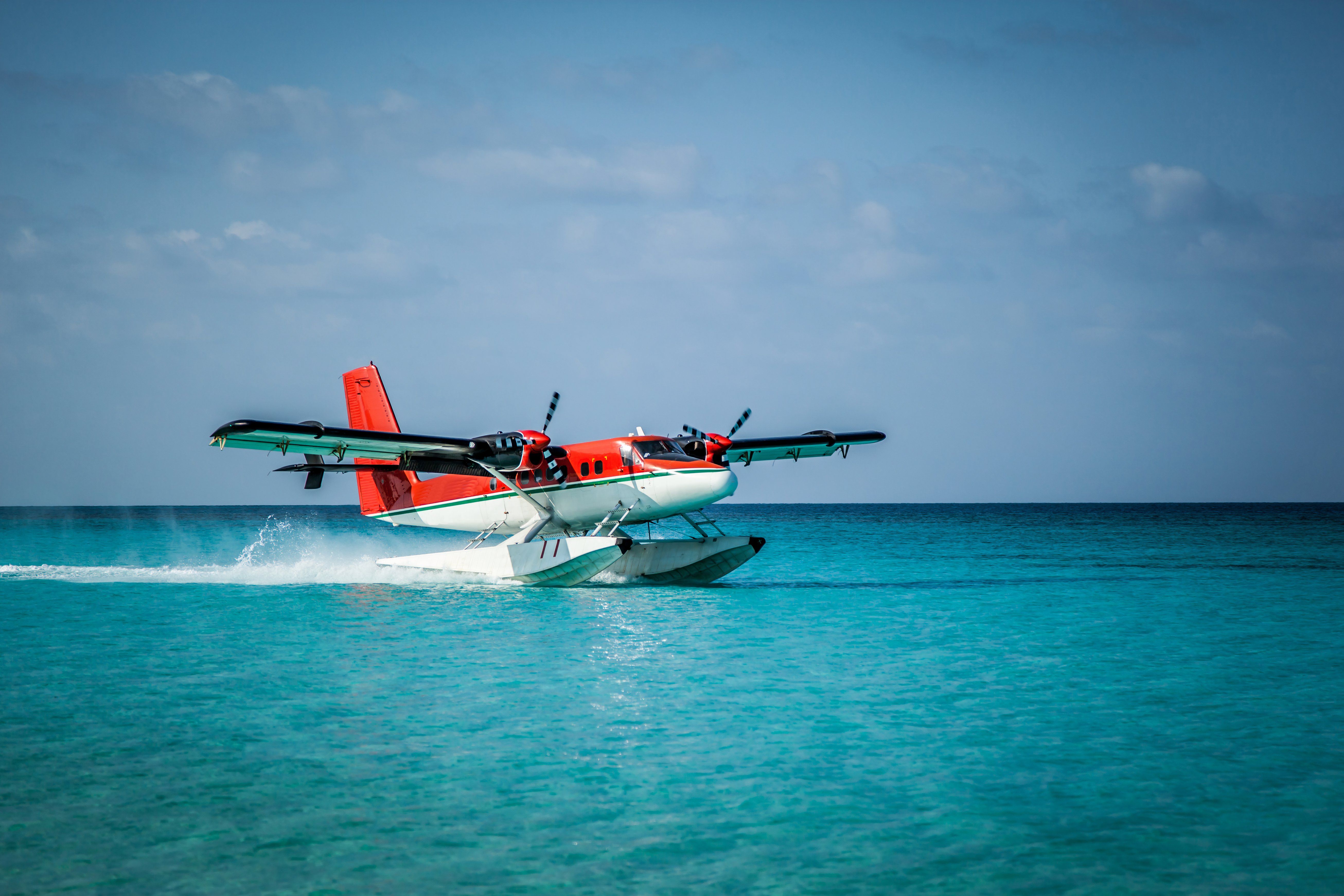  Seaplane landing in the ocean lagoon. 