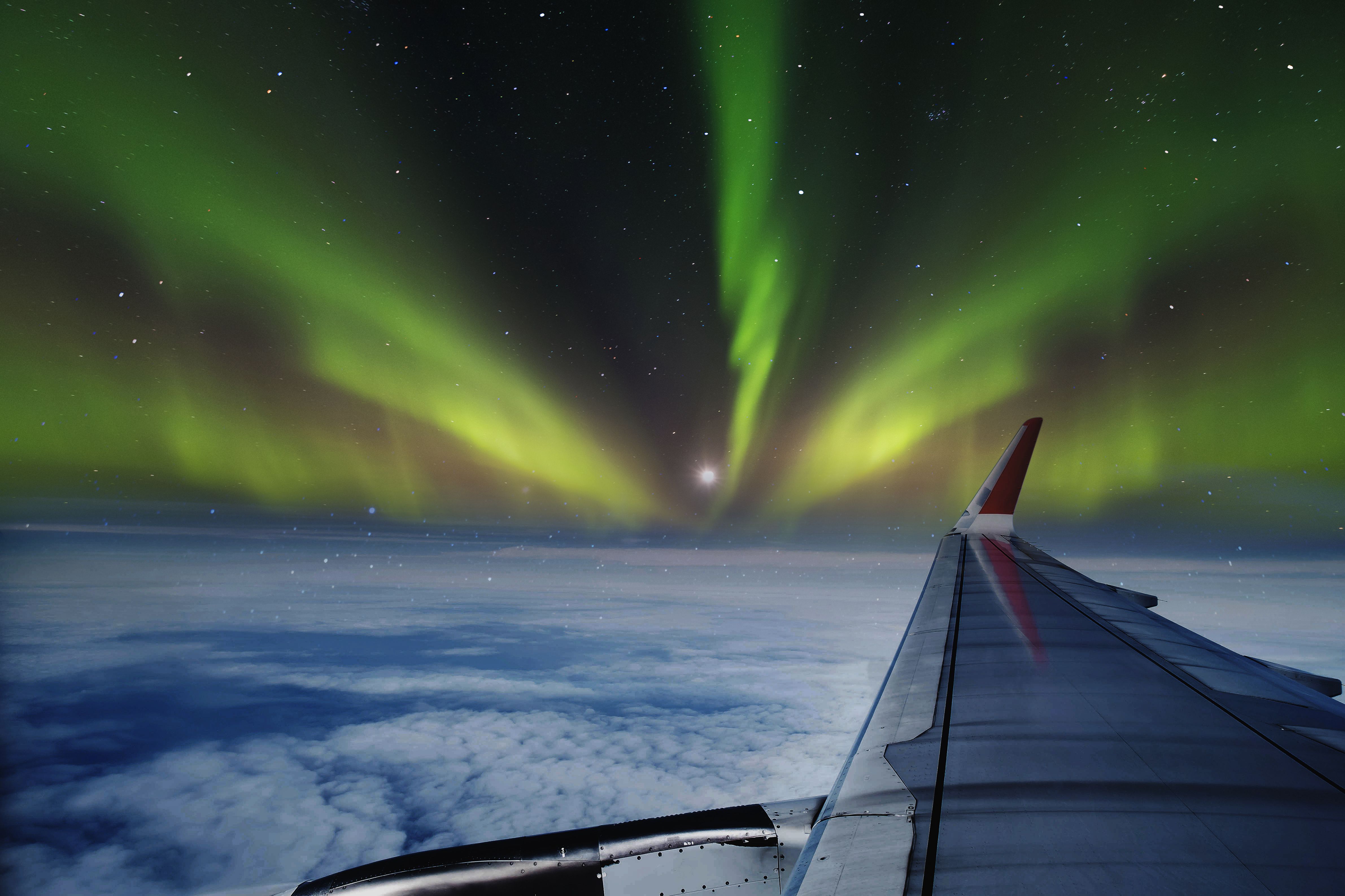 Aerial view of Northern Lights (Aurora Borealis) from window of an flying airplane.