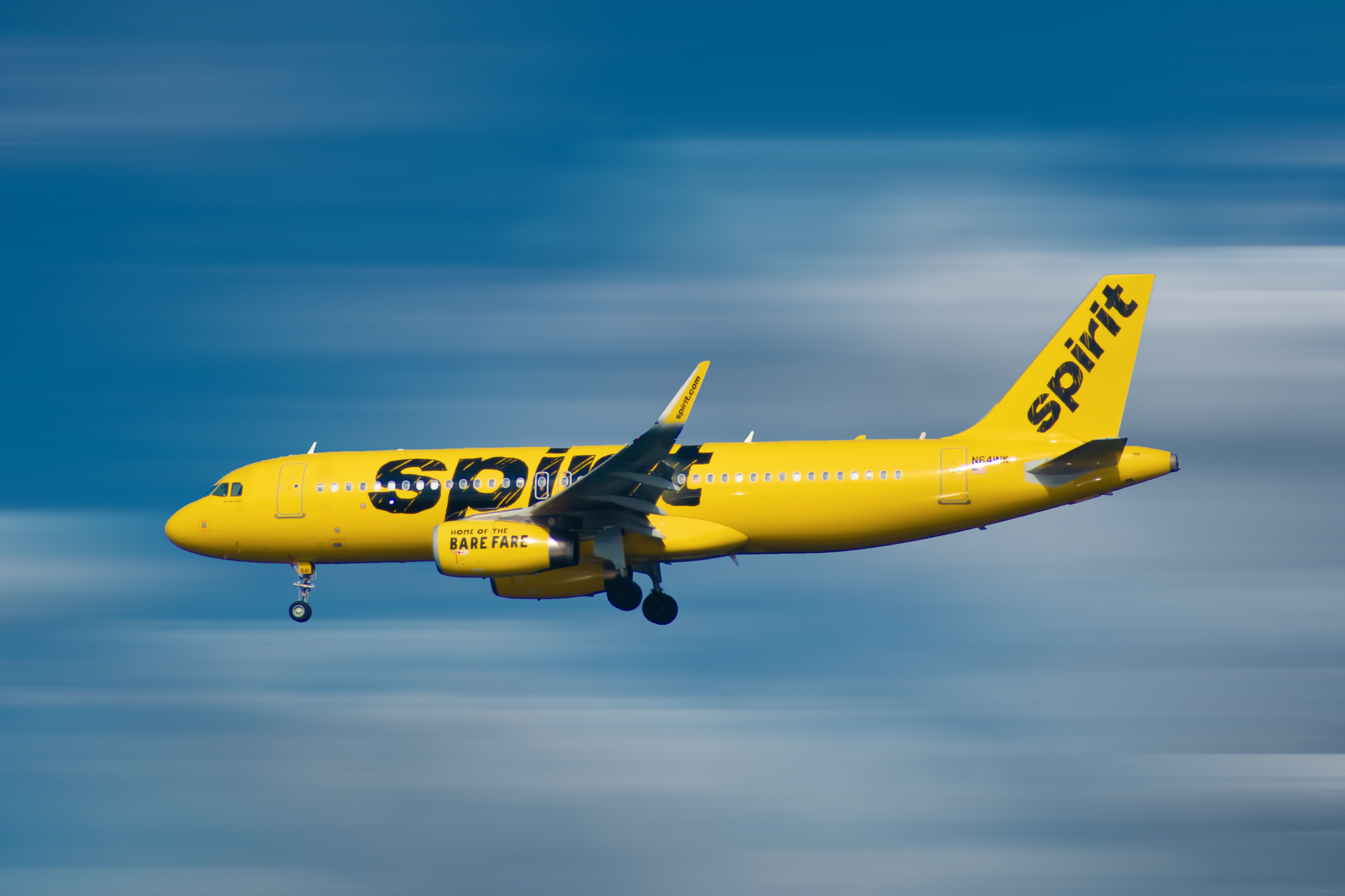 Spirit Airlines Airbus A320 landing at Orlando International Airport MCO shutterstock_1537700198