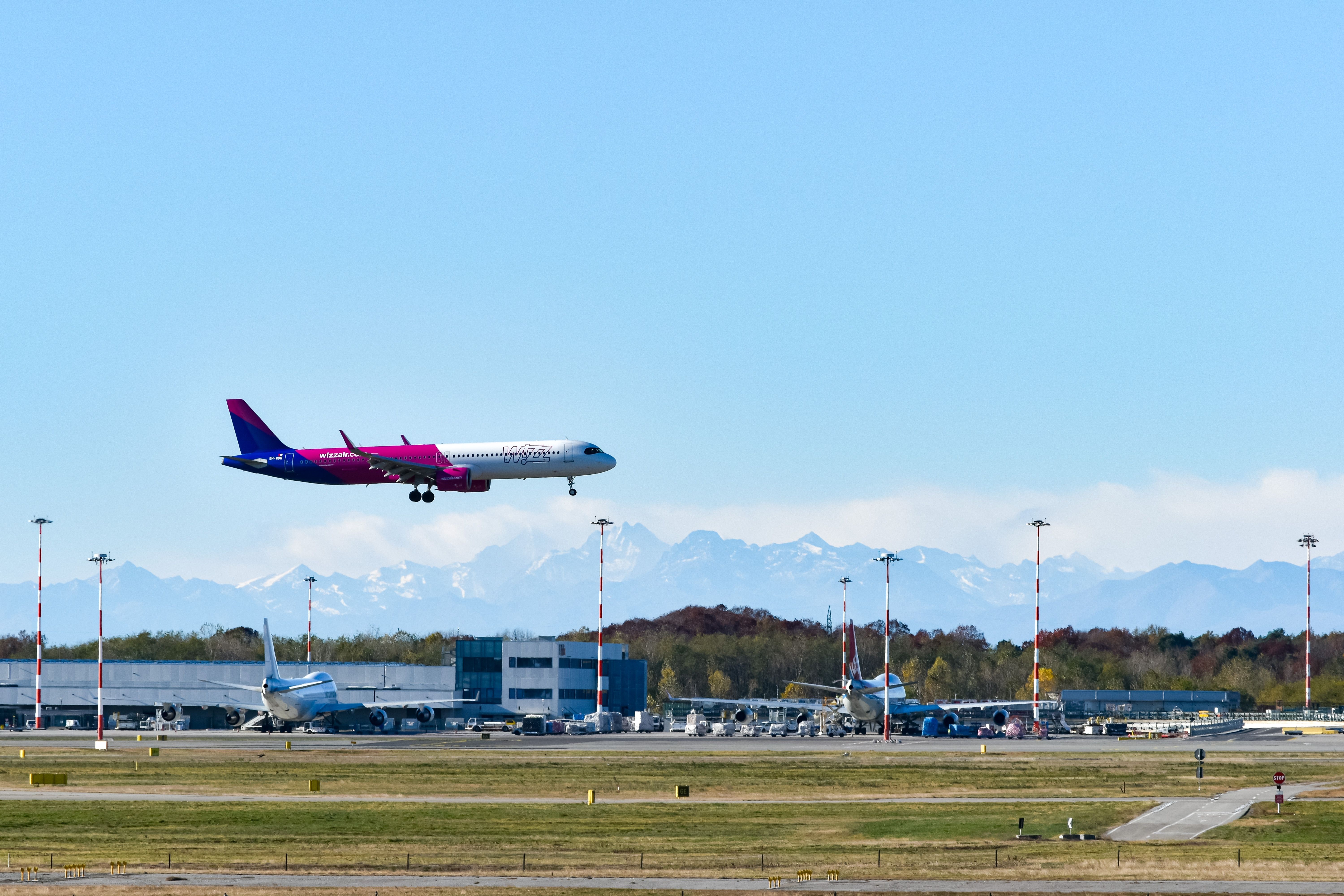 Wizz Air Airbus A321neo landing at Milan Malpensa Airport MXP shutterstock_2396242299