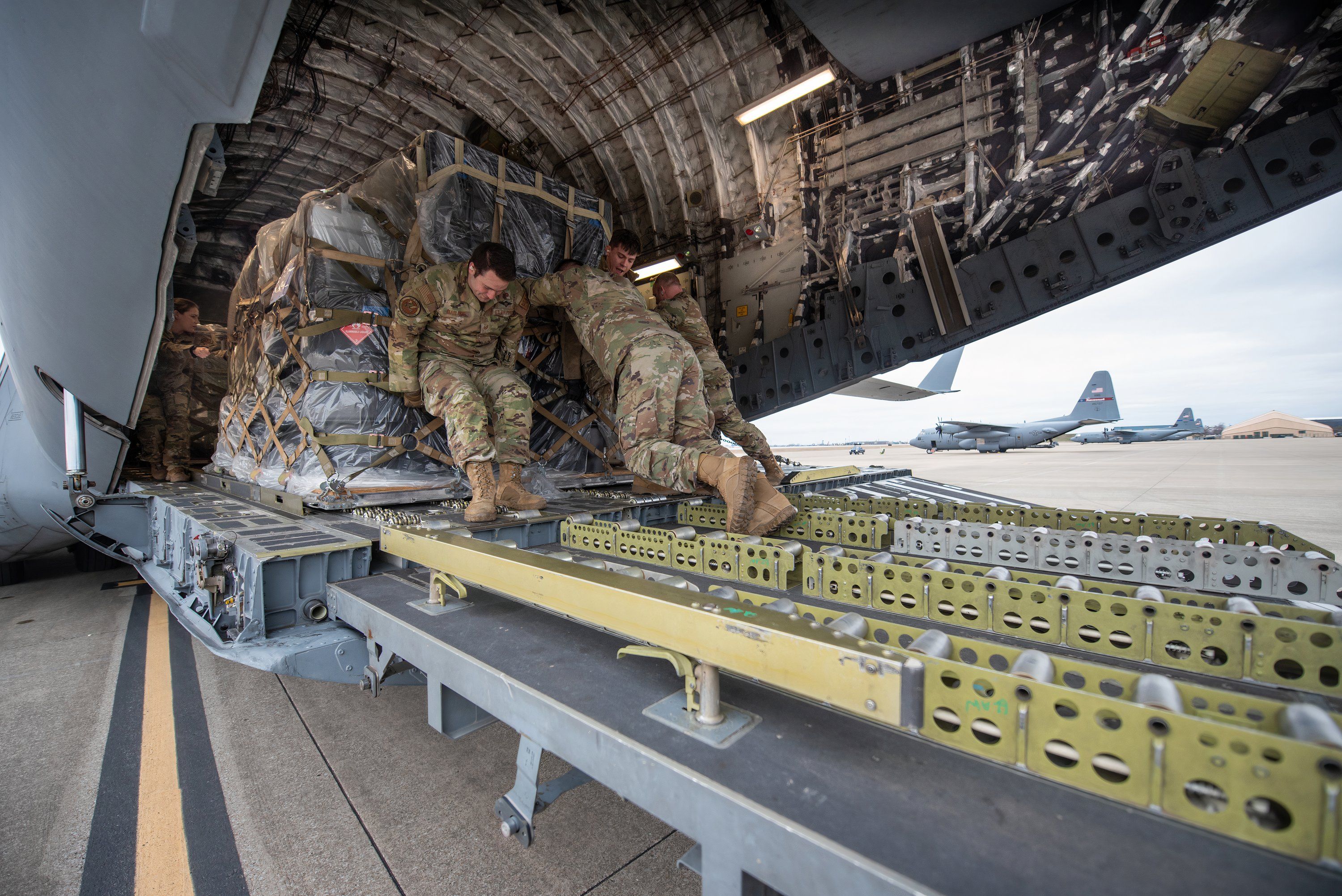 Members of the 123rd Logistics Readiness Squadron load a pallet of cargo onto a North Carolina Air National Guard C-17 Globemaster III 