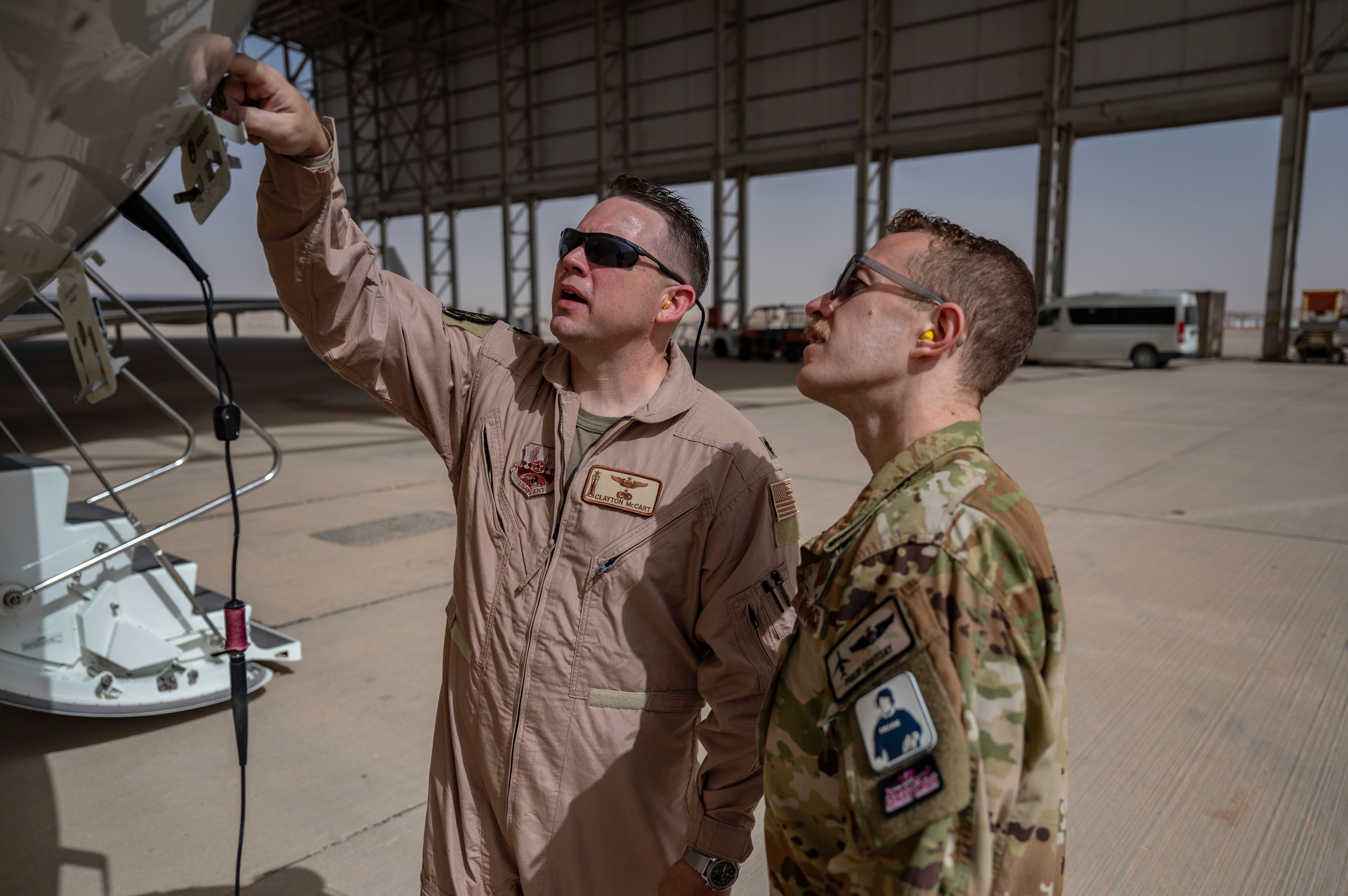 Photo of USAF Lt. Col. McCart with another squadron member inspecting the E-11A