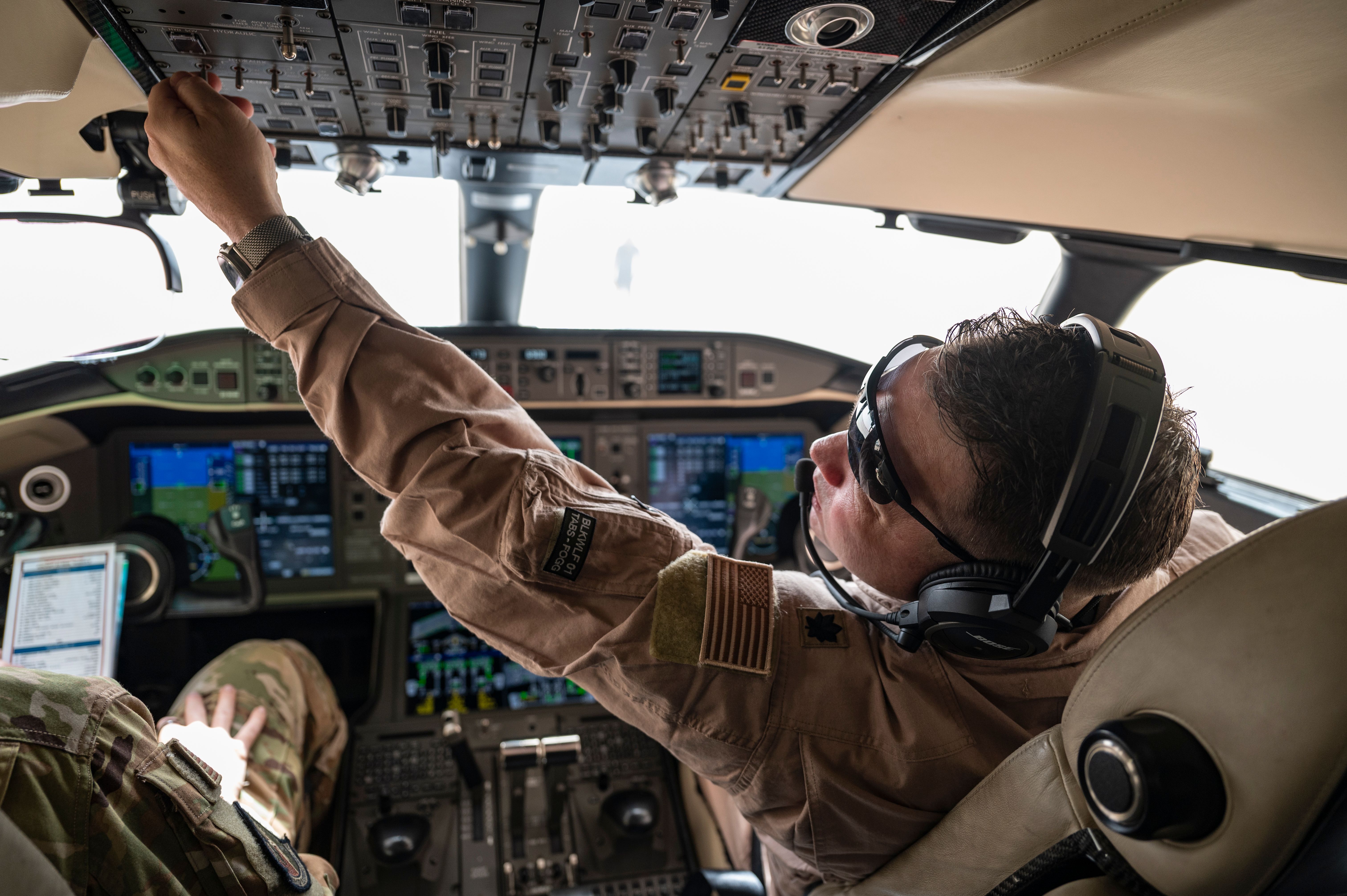 Photo of a USAF E-11A pilot during preflight procedures